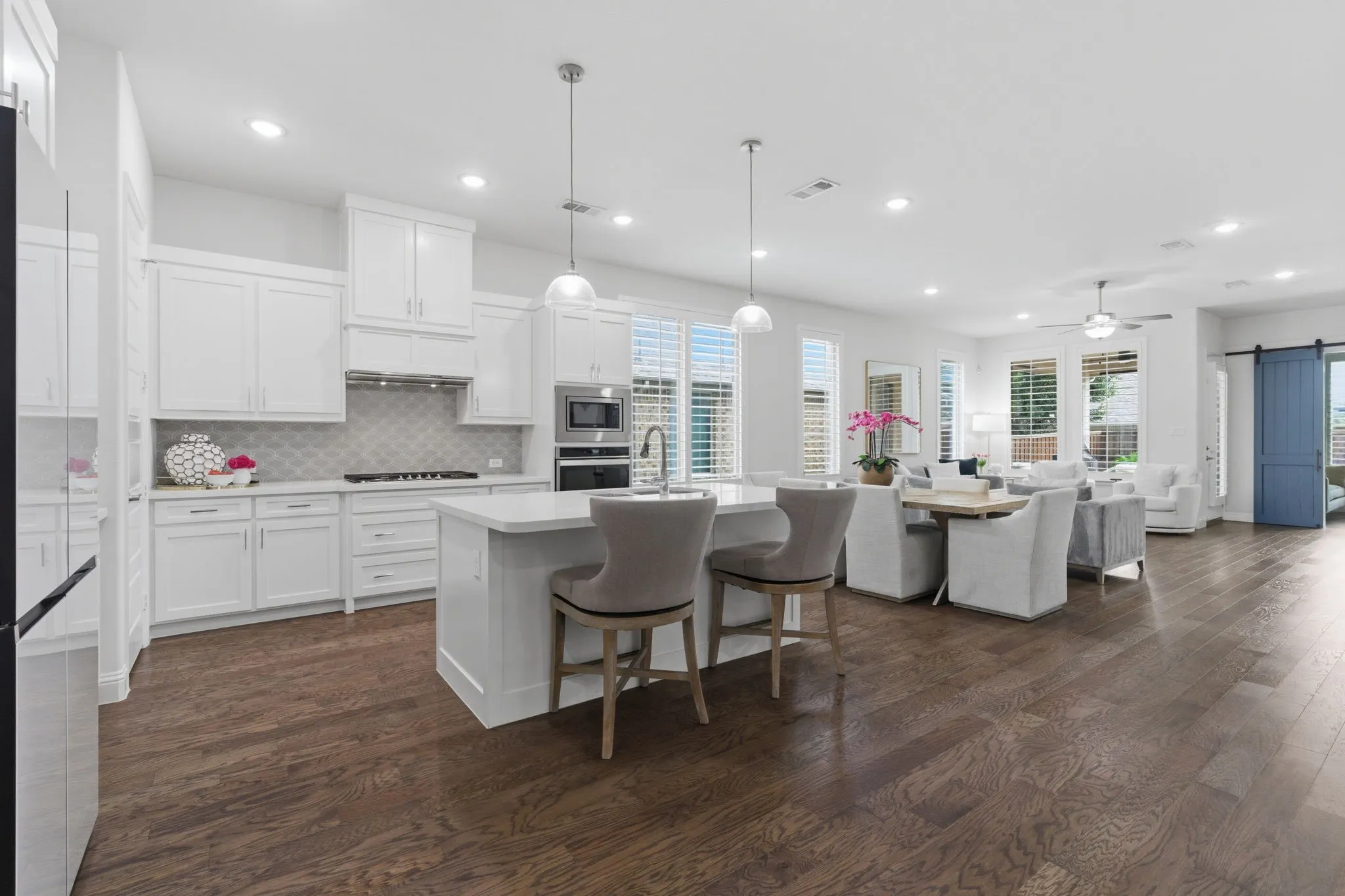 Designed for easy flow, the kitchen opens to the dining area & living room, creating a seamless, connected living environment. The high ceilings & expansive wood floors  make it feel large yet cozy!