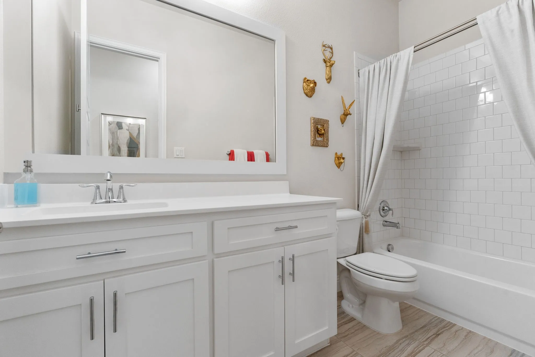 Pristine full bath 3 is convenient for resident & guest use, located between bedrooms 3 & 4.