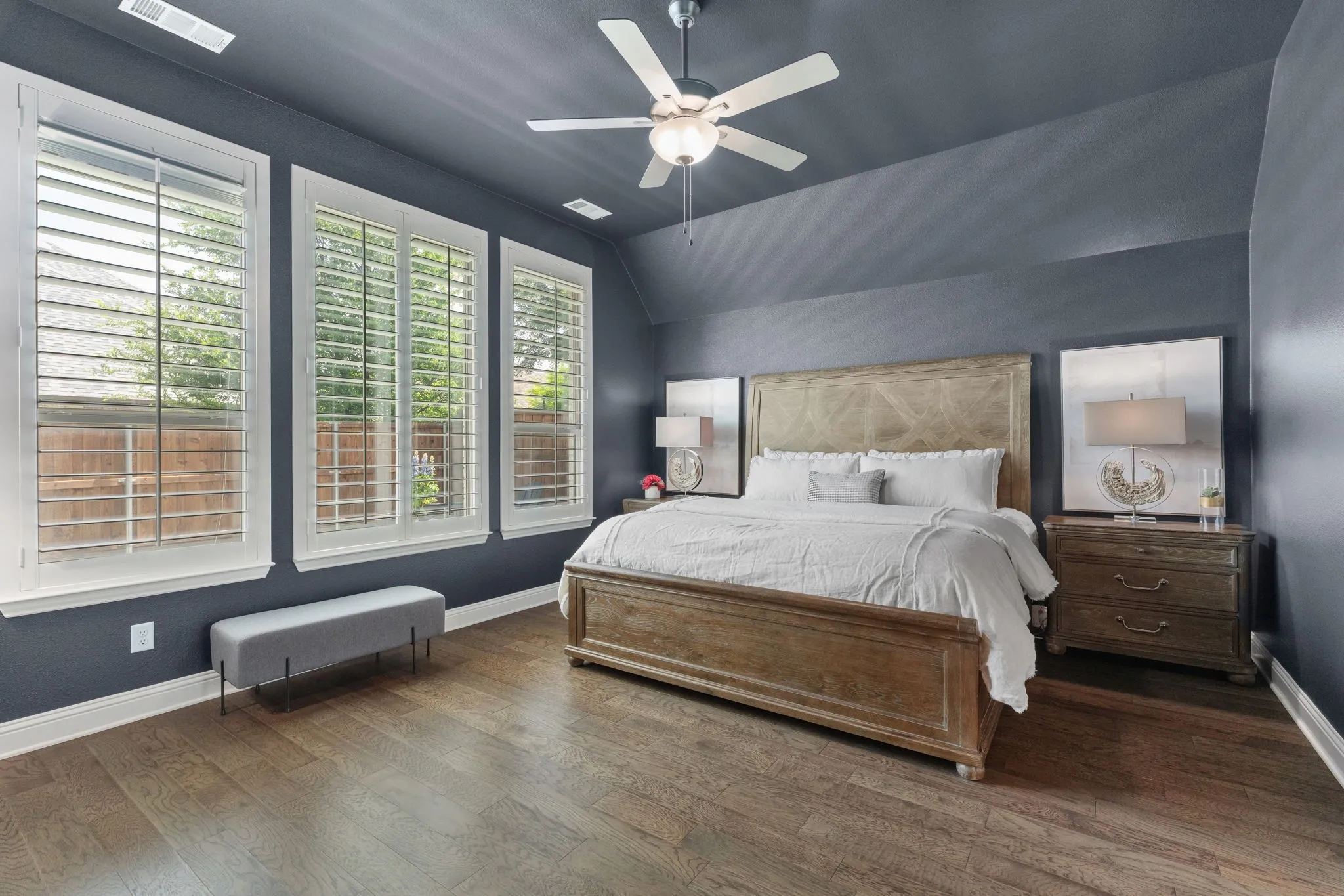 Dramatic describes the first impression of this secluded, large primary bedroom. Rise & shine with views of the swimming pool :)