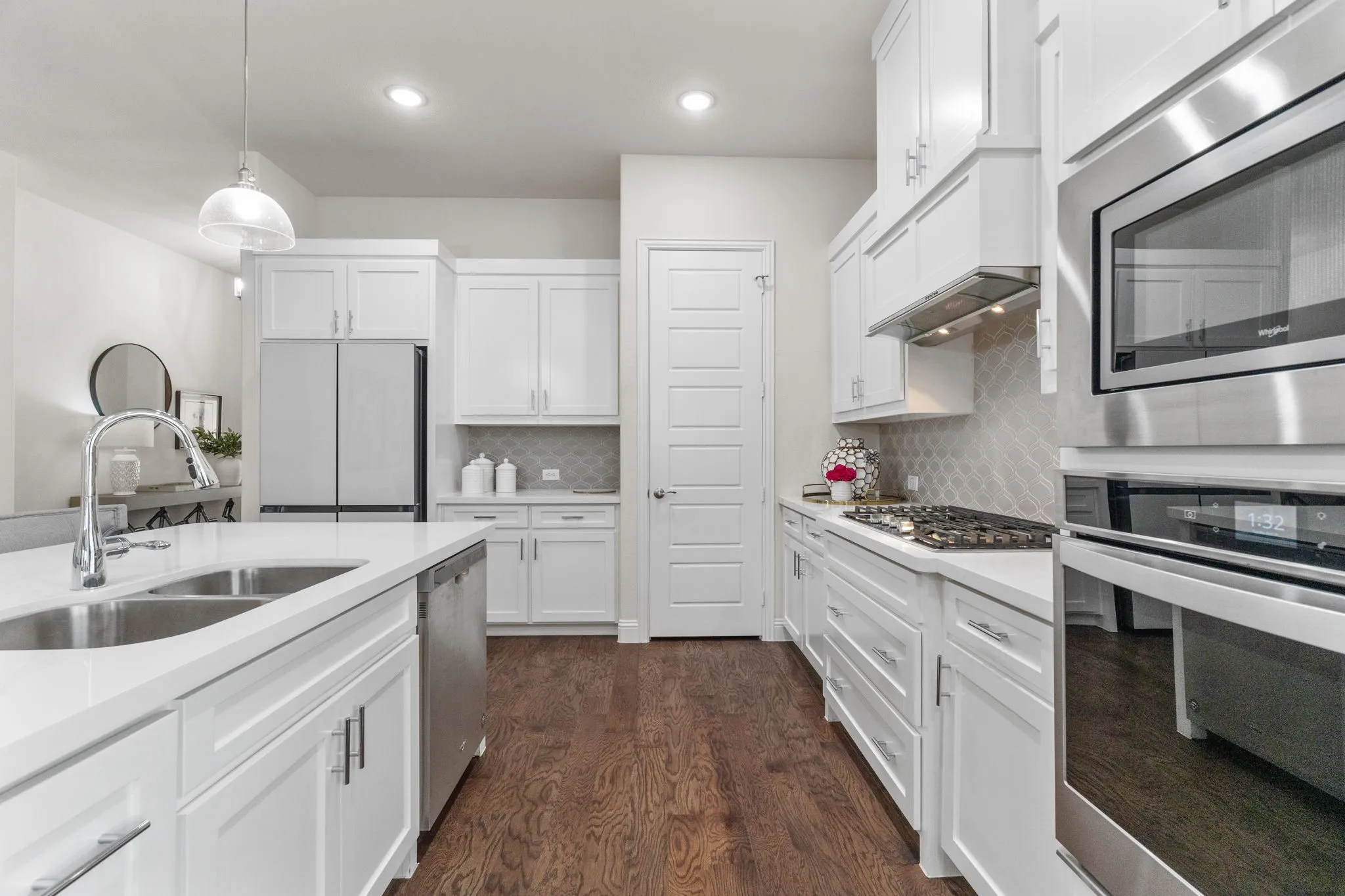 Ample cabinet storage + a corner walk-in pantry means a very functional kitchen to work in. Immaculate describes every inch of this home!