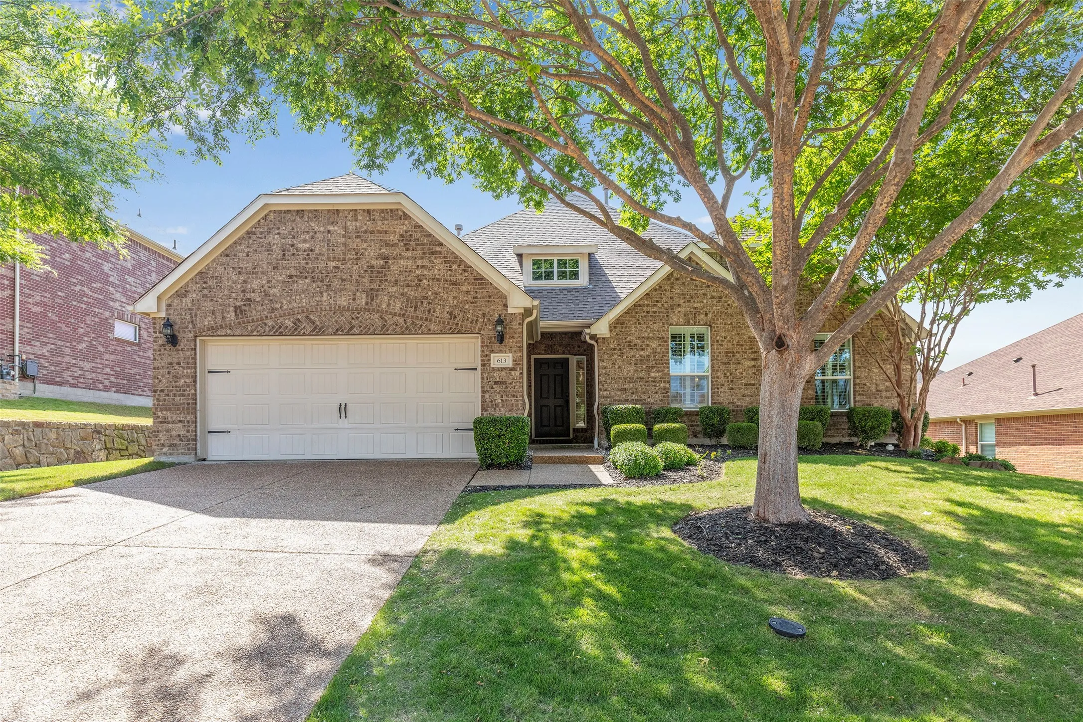Mature shade trees and timeless brick elevation create standout curb appeal.
