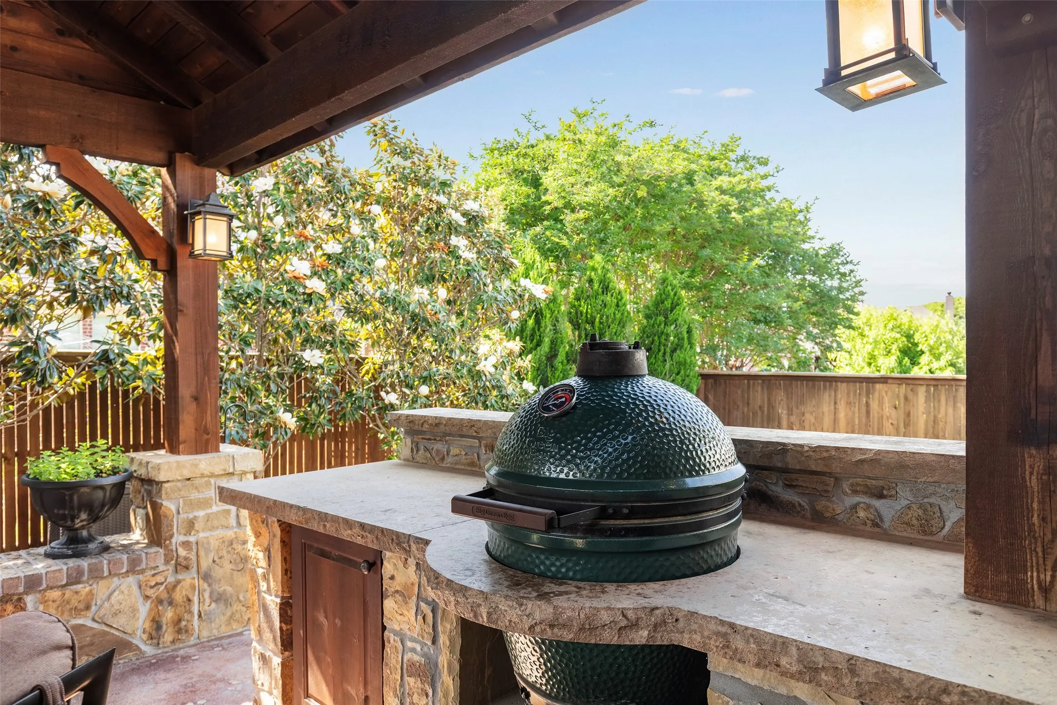 Outdoor kitchen featuring a built-in Big Green Egg great for entertaining or quiet dinners at home.