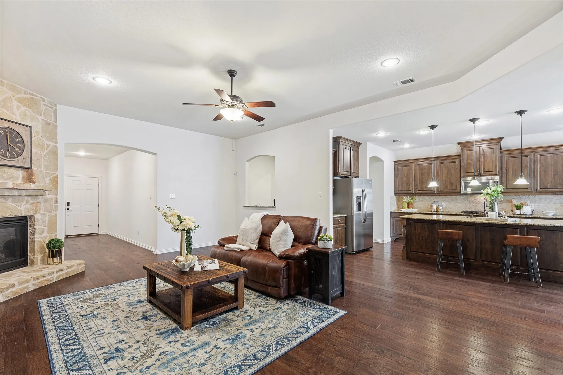 Open-concept living with rich hardwood flooring and seamless flow into the kitchen.