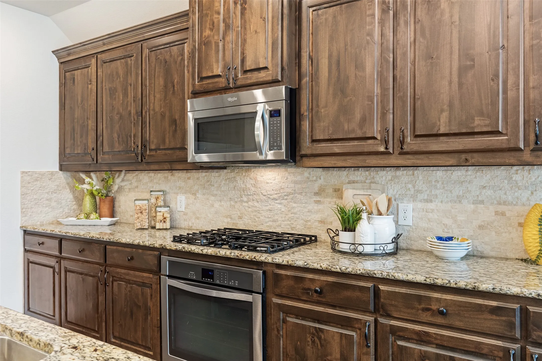Chef-inspired kitchen with gas cooktop, granite counters, and abundant prep space.