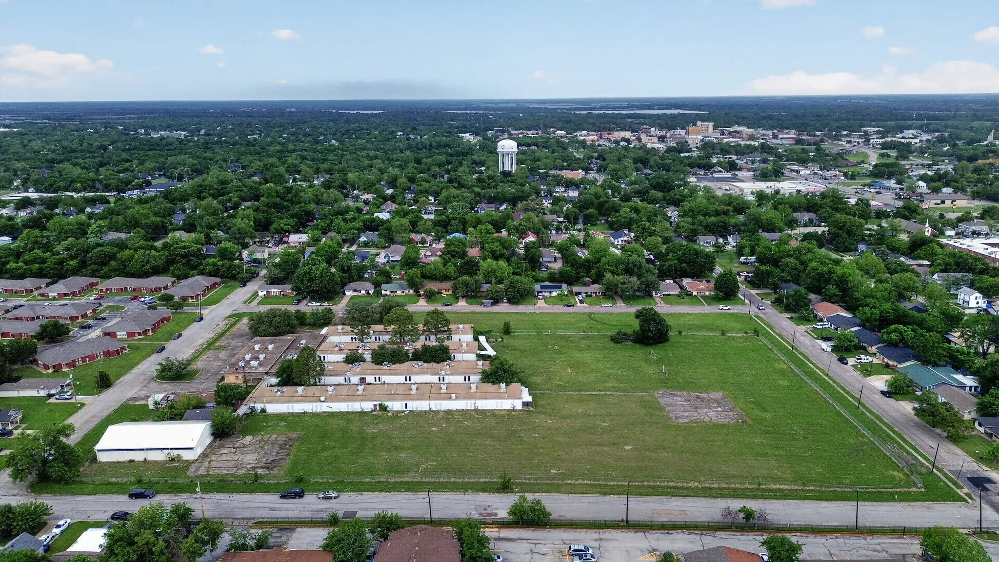 Expansive undeveloped land parcel with surrounding residential areas and infrastructure