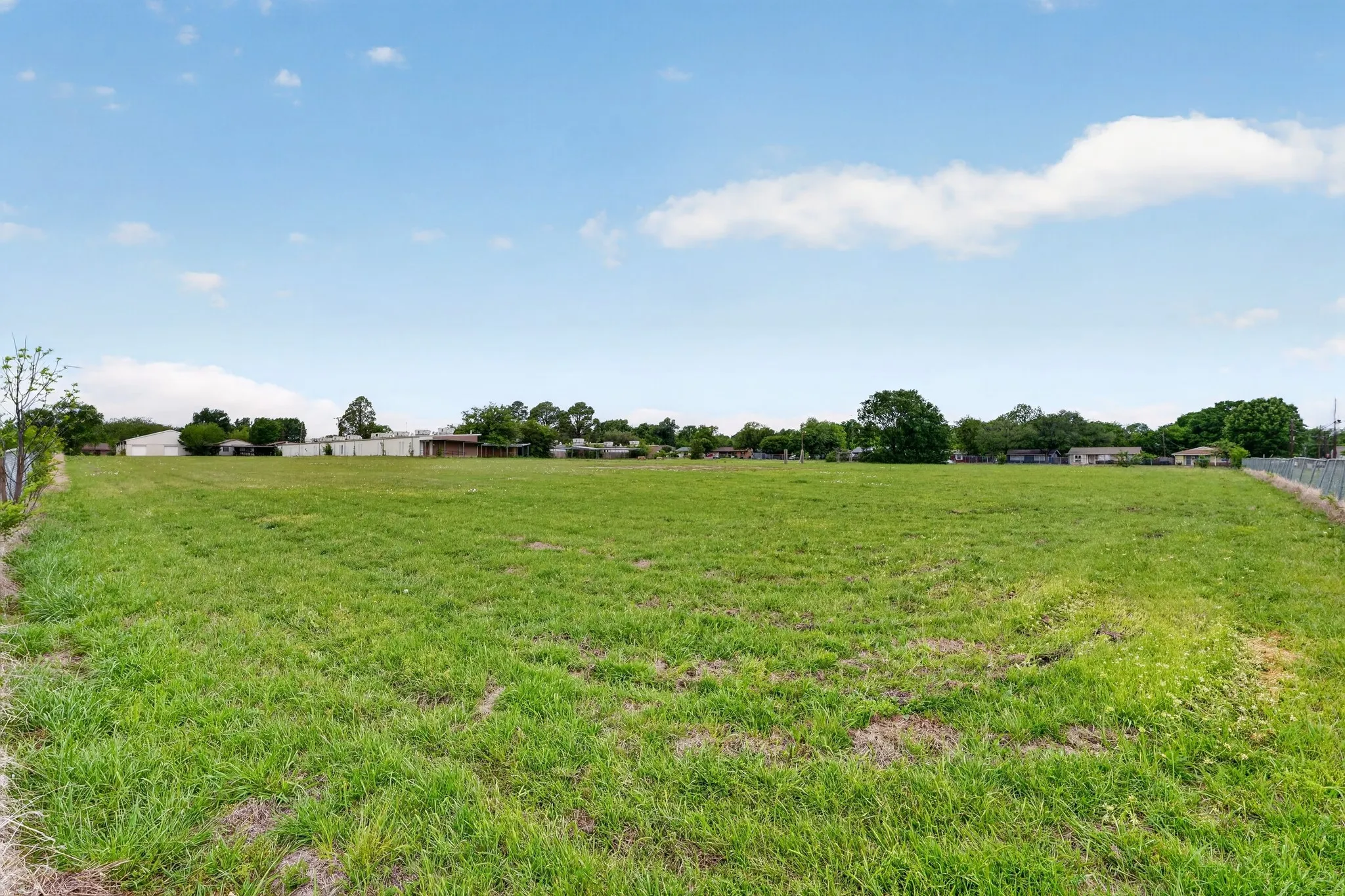 Expansive green space featuring a large grassy lot