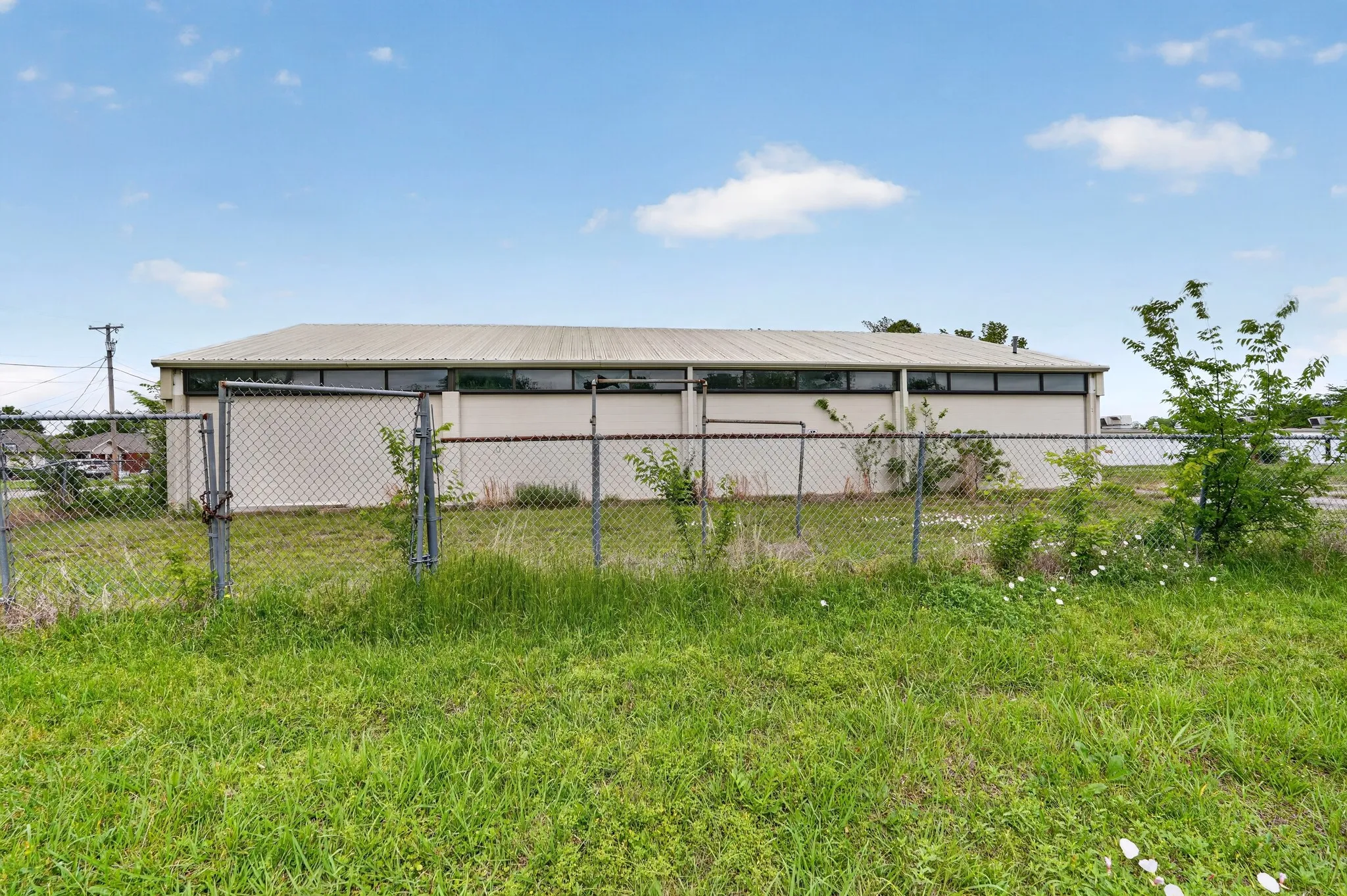 Commercial building with a metal roof and an upper band of windows