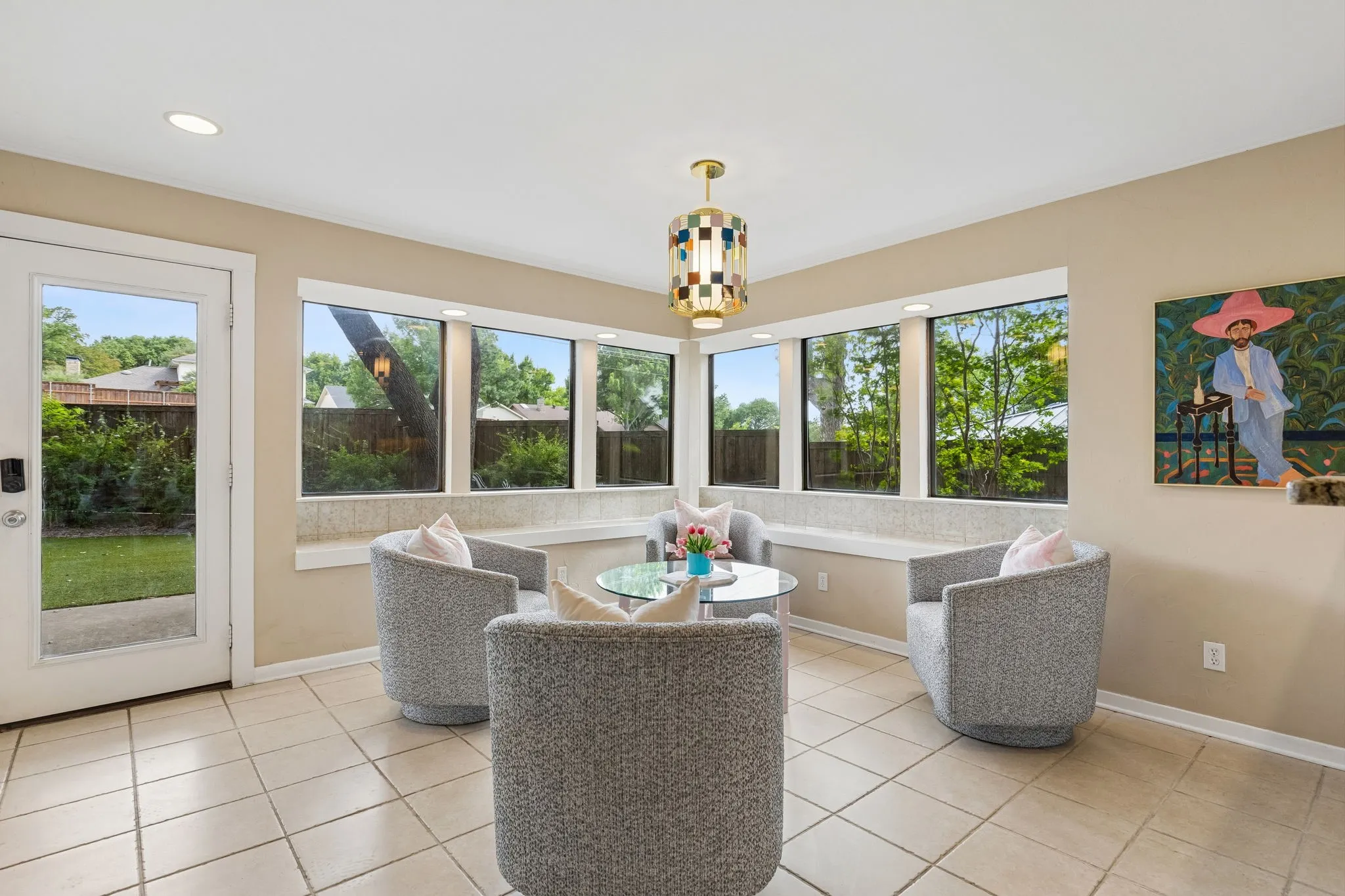 Bright interior space featuring a multi-pane glass door, tile flooring, and recessed ceiling lights