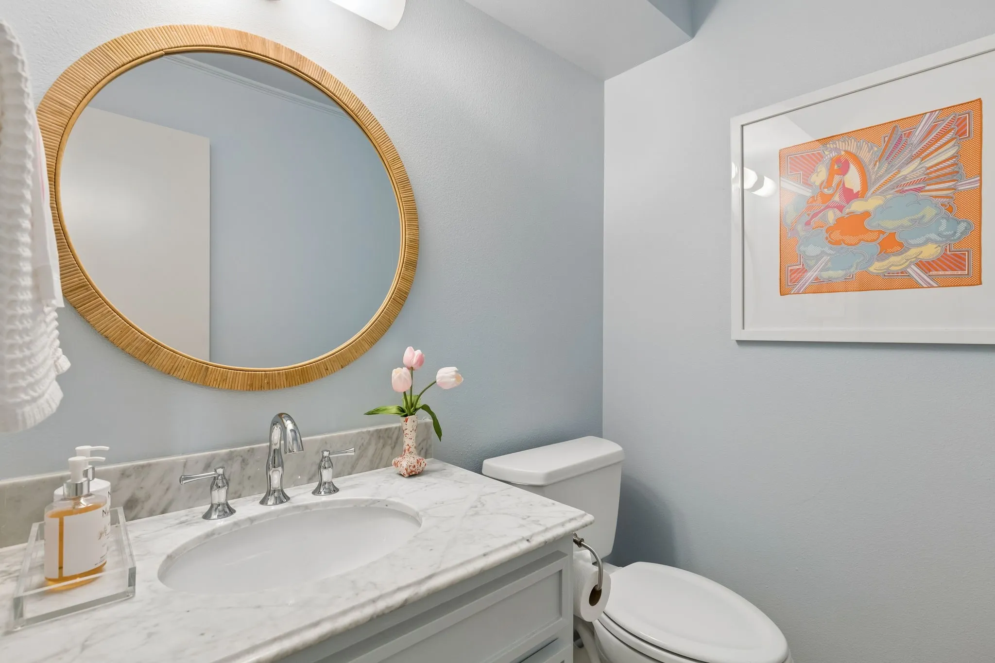 Bathroom featuring a white vanity with an undermount sink, chrome faucet, and a light-toned countertop