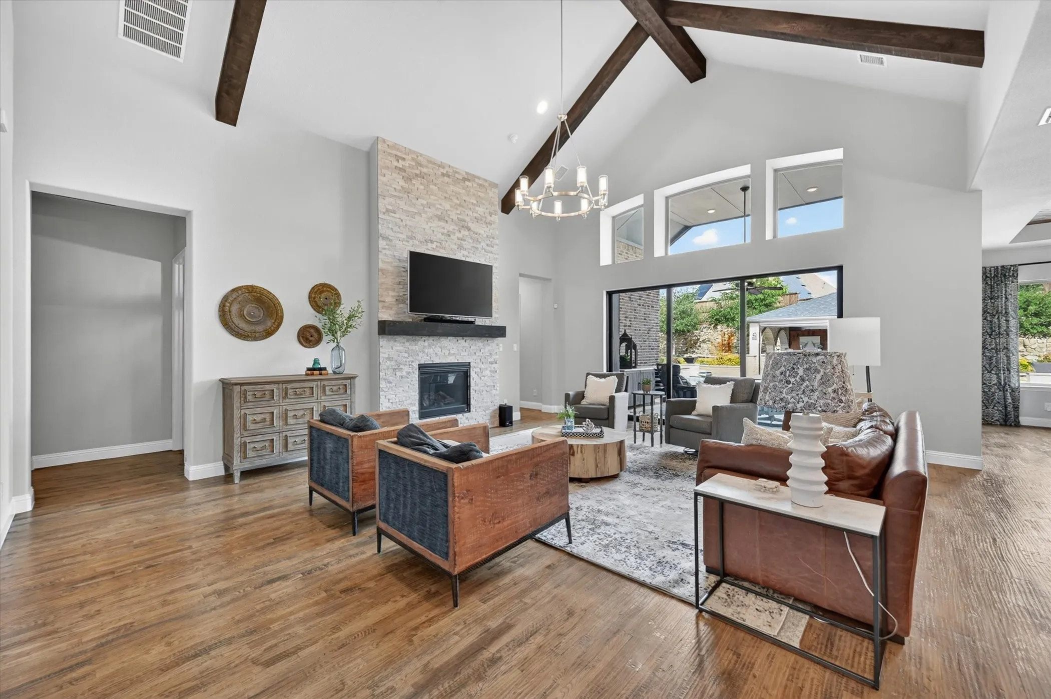 From the moment you enter, your eye is drawn through expansive 3-panel sliding pocket doors to a stunning pool view, creating a seamless indoor-outdoor living experience.
