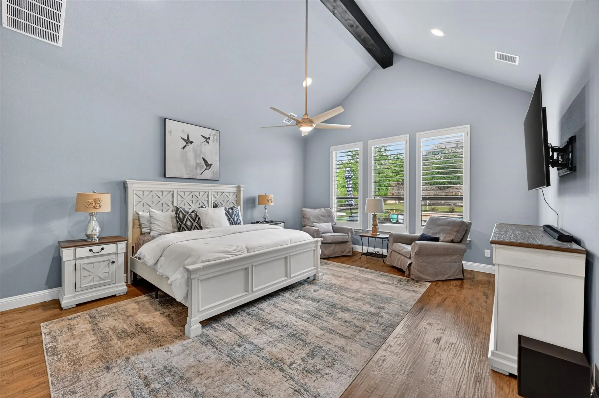 The private primary suite is a true retreat, with direct laundry room access, two expansive custom walk-in closets, and a spa-like bath featuring an oversized semi-frameless shower, soaking tub, and separate granite vanities.