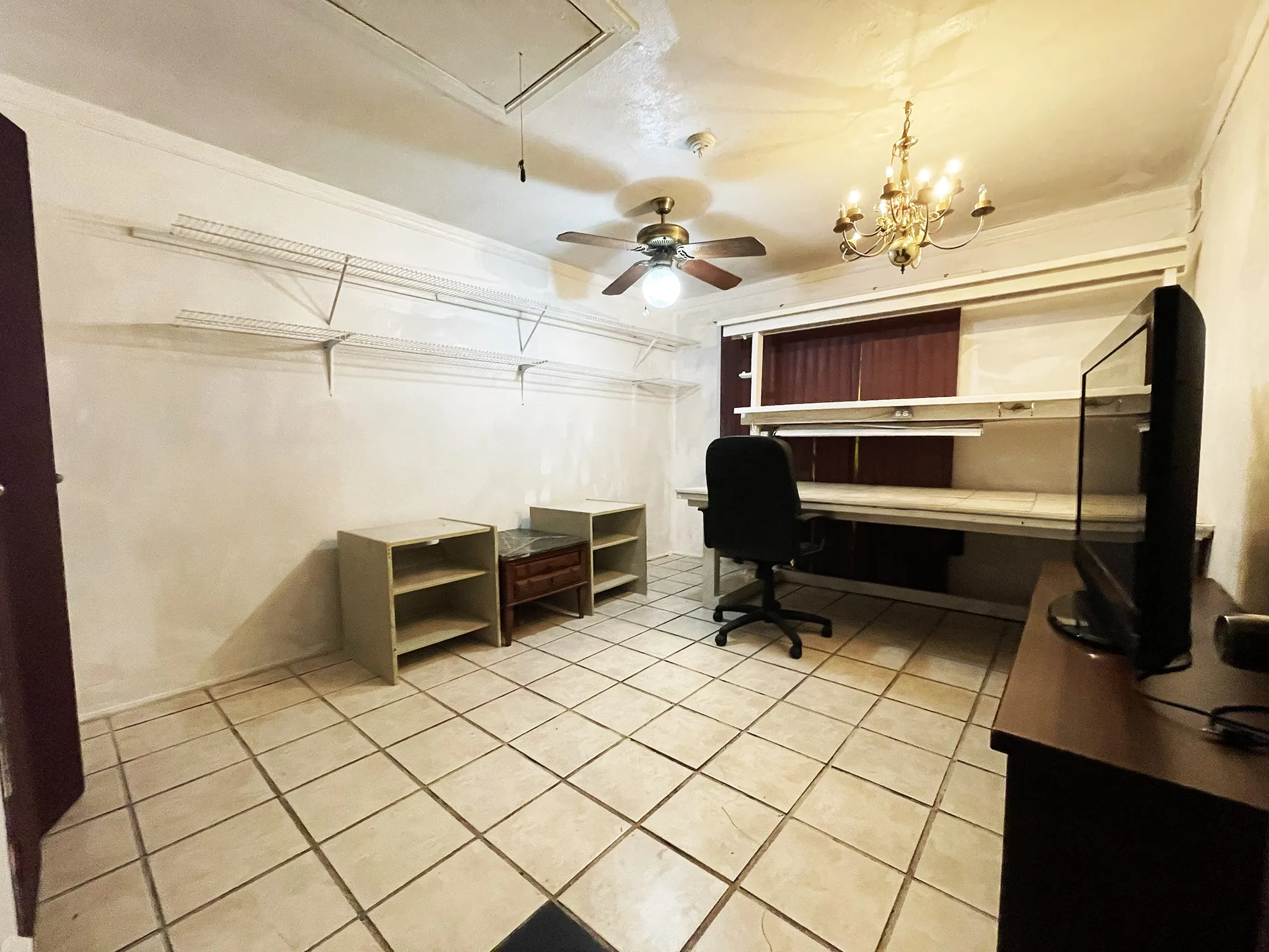 Room featuring tile flooring and built-in shelving