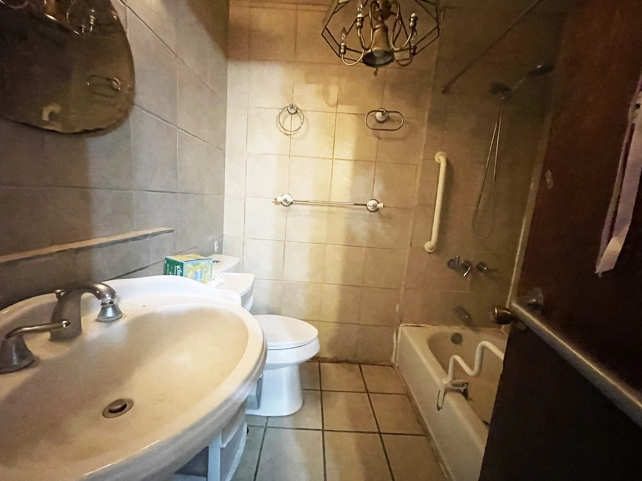 Bathroom featuring a single vanity sink, ceramic tile flooring, and a bathtub with shower