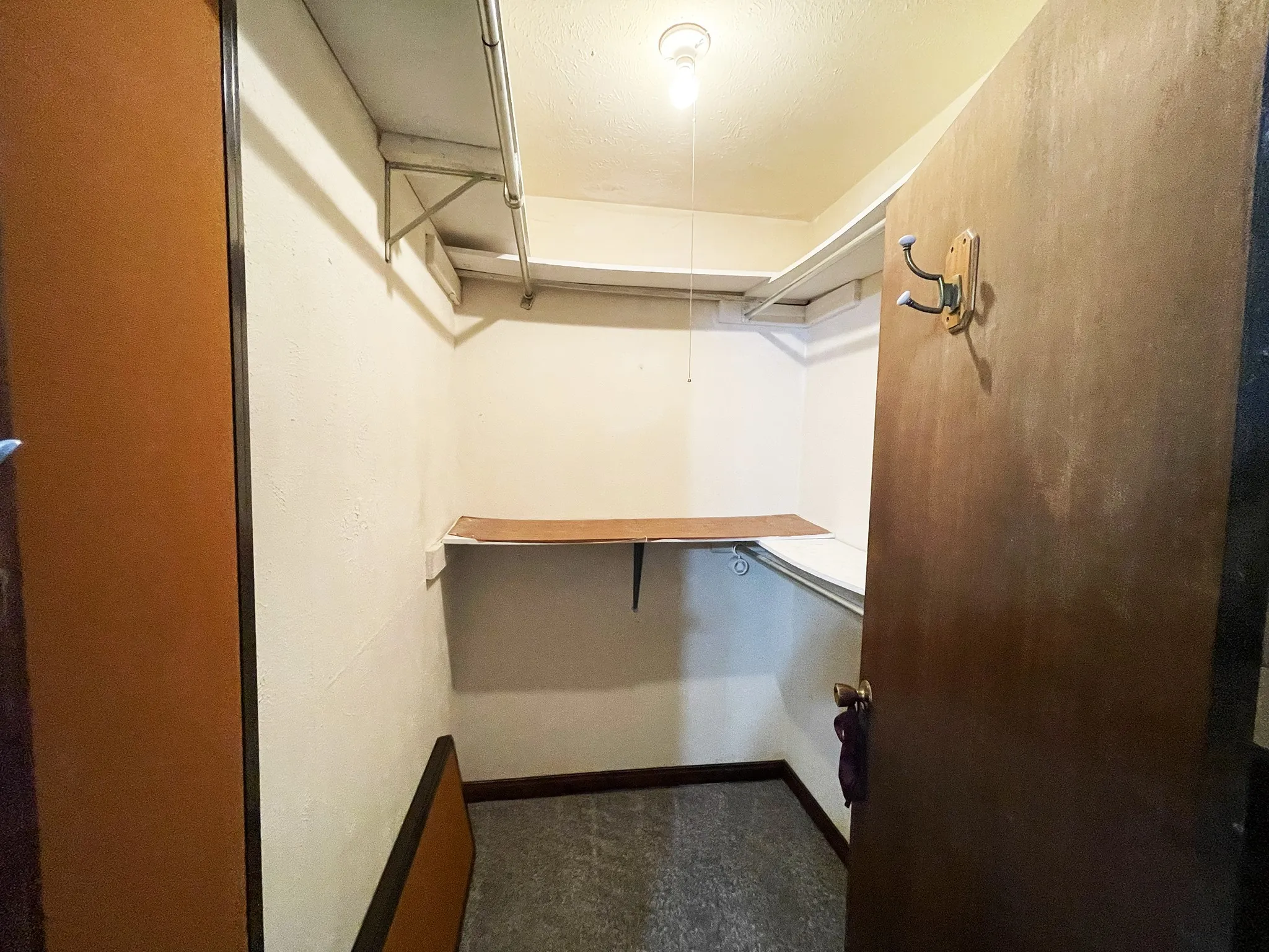 Walk-in closet featuring extensive shelving and hanging rods