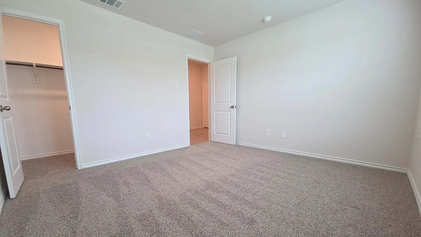 Neutral-toned carpeting and light-colored walls define this room