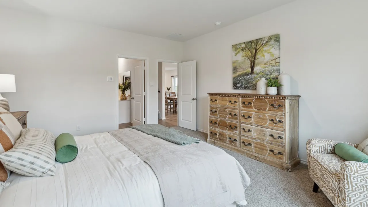 Carpeted bedroom with a vaulted ceiling