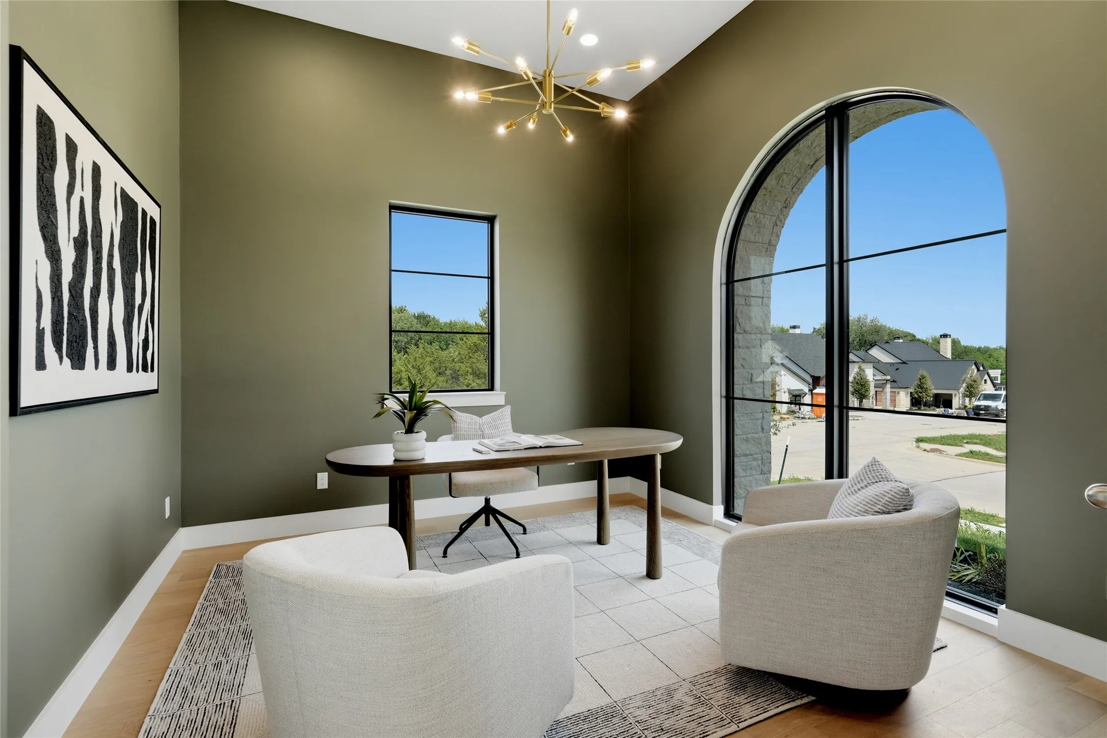 Room with a striking arched window and a secondary rectangular window