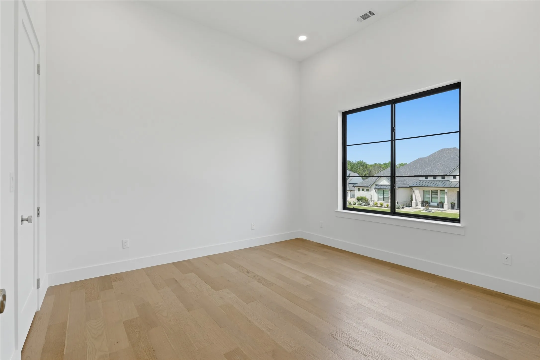 Bright interior space with light wood-finish flooring