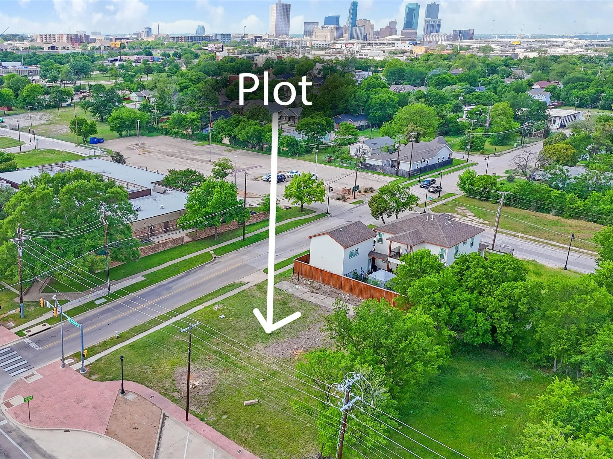 Cleared, undeveloped land parcel featuring mature trees, street frontage, and established infrastructure