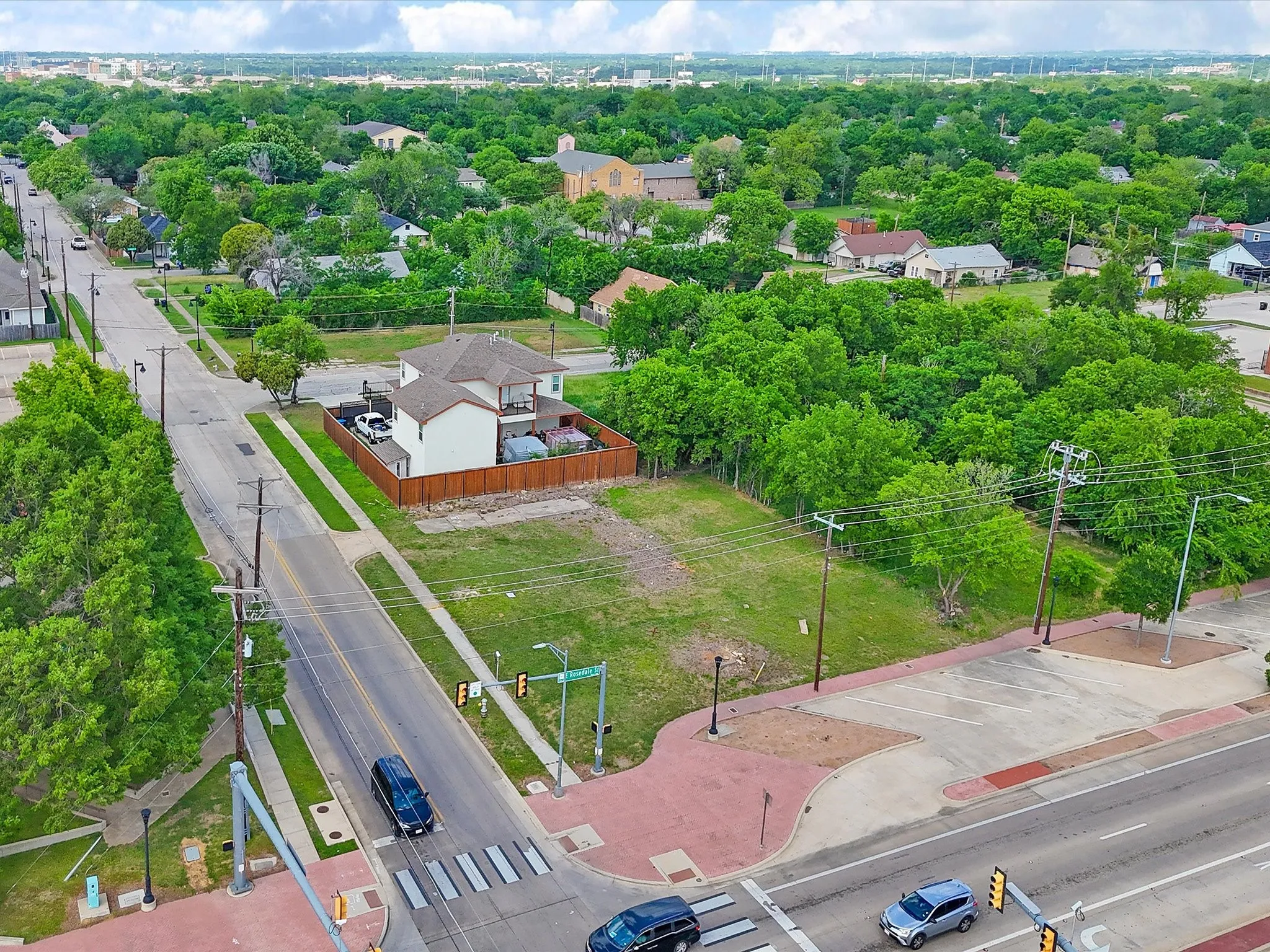 Aerial perspective showcasing a corner lot with surrounding streets
