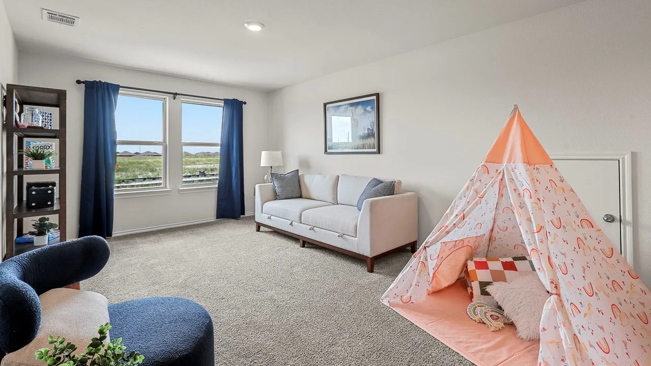 Spacious room featuring light gray carpet, white walls, and a recessed ceiling light