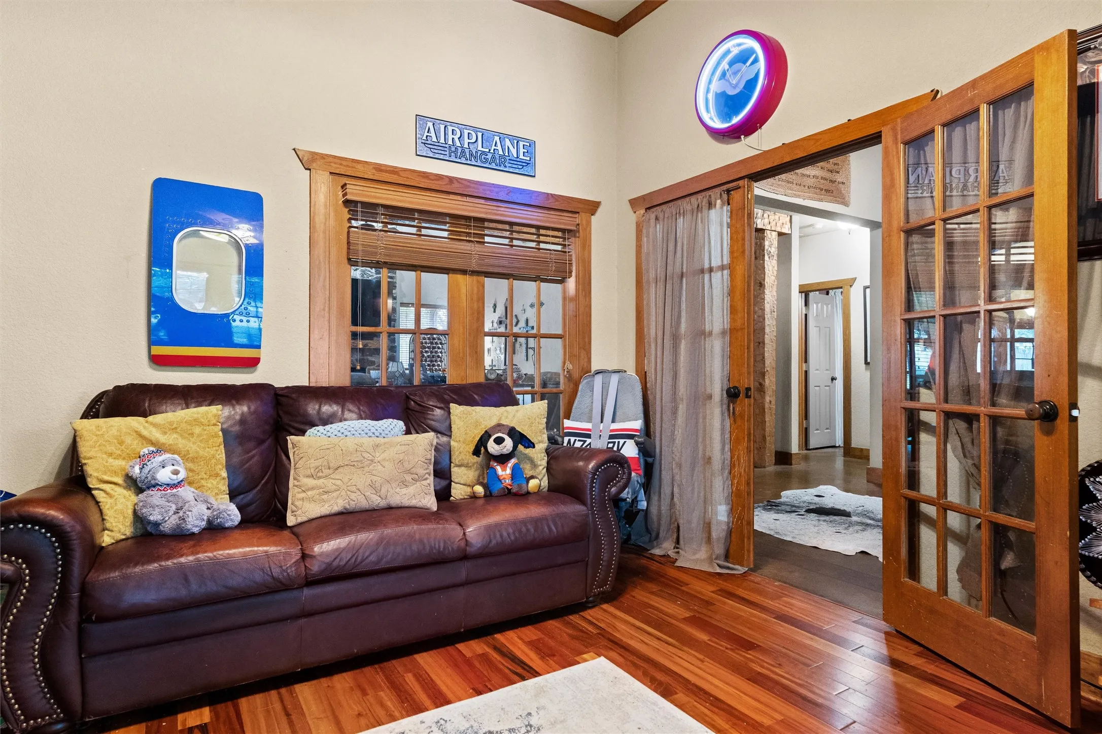 Dedicated office at the front of the home with wood flooring and double doors.