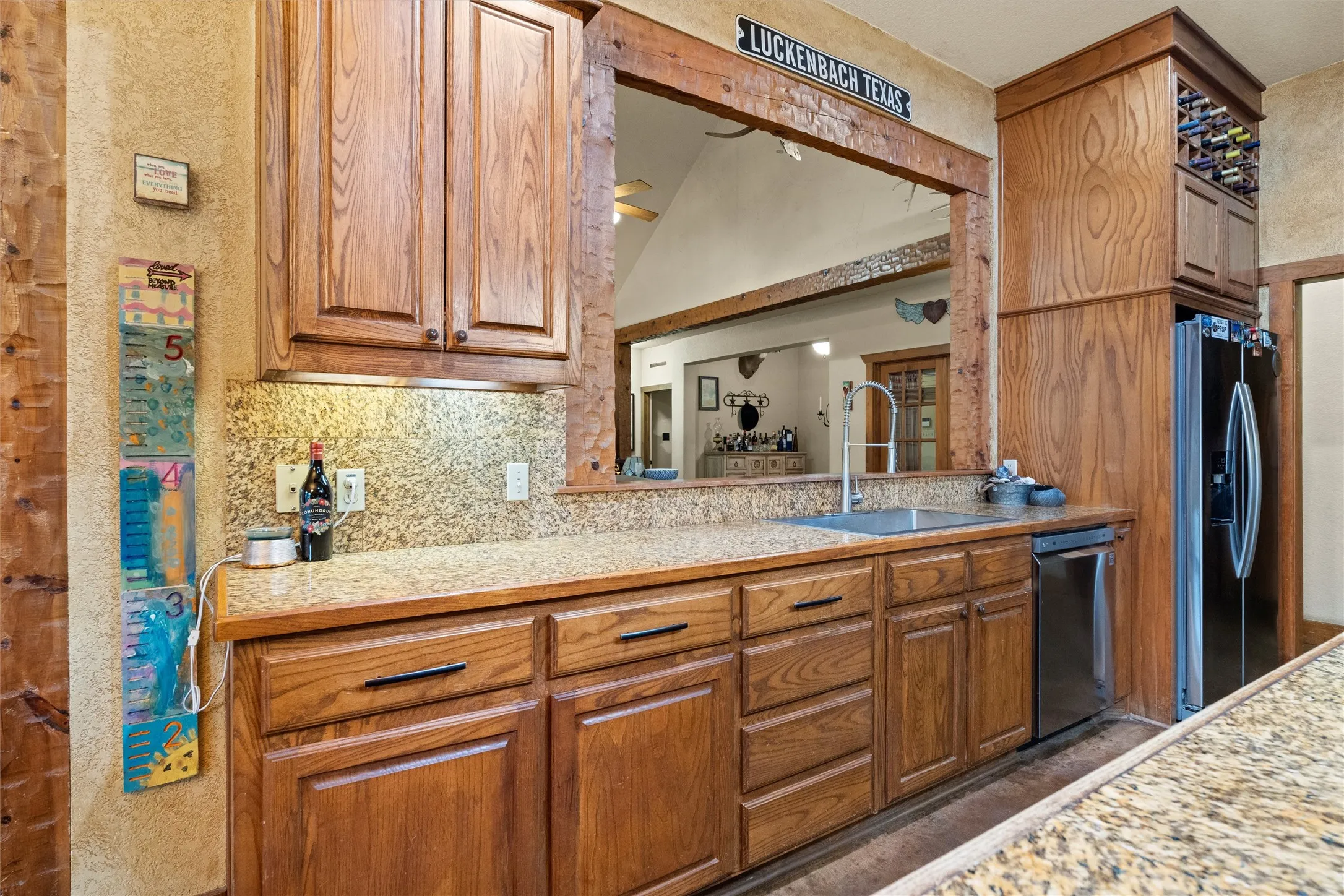 This large window from the living room to the kitchen is perfect for keeping the family together.