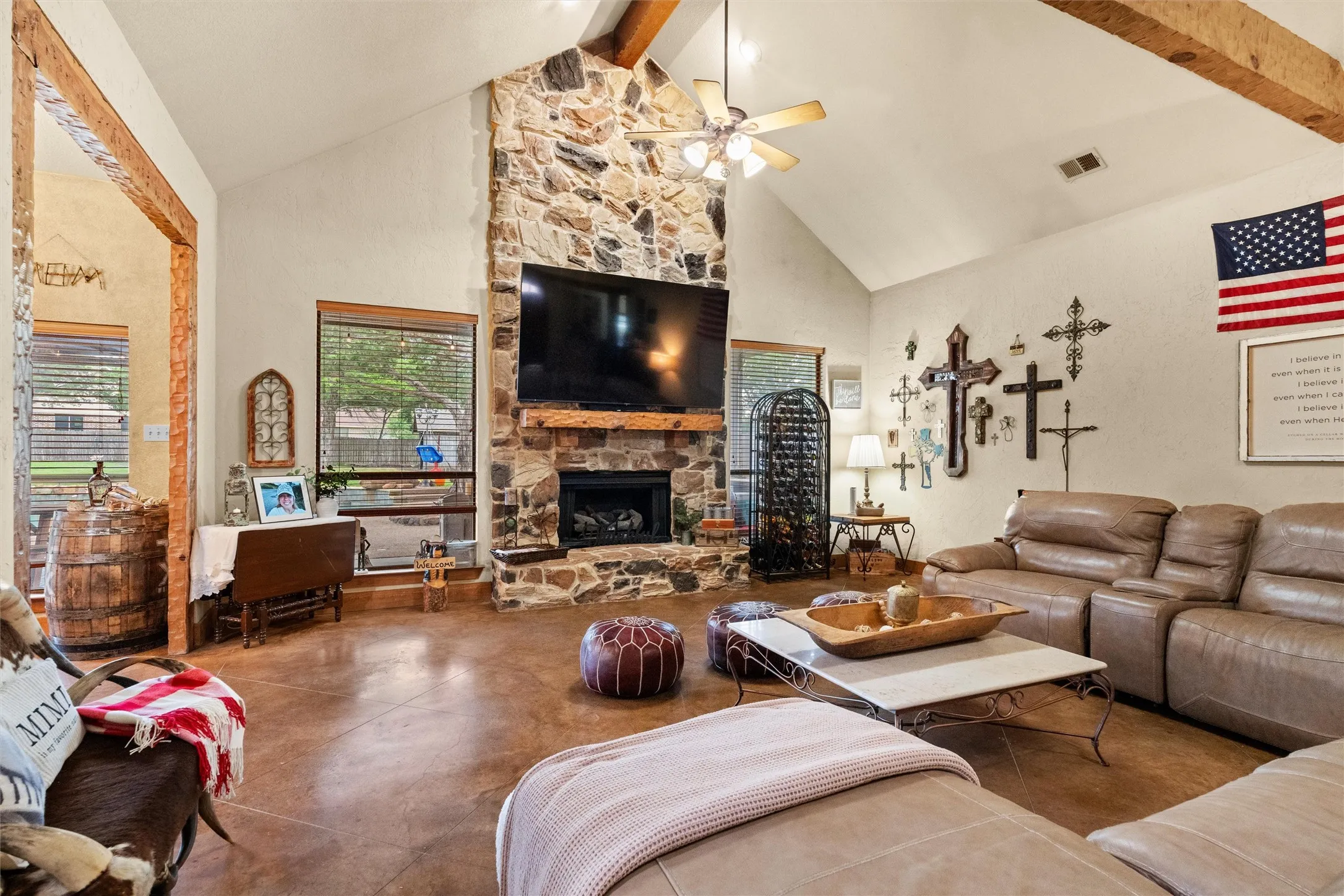 High ceilings, hand carved wood framing and stained concrete floors make this room impressive.
