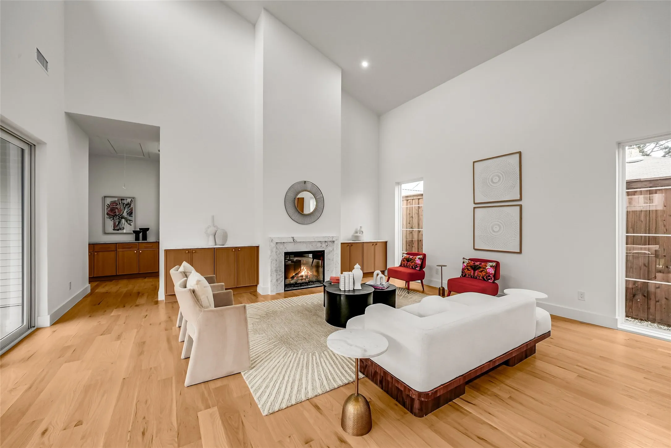 Spacious living area featuring soaring vaulted ceilings and light wood-finish flooring