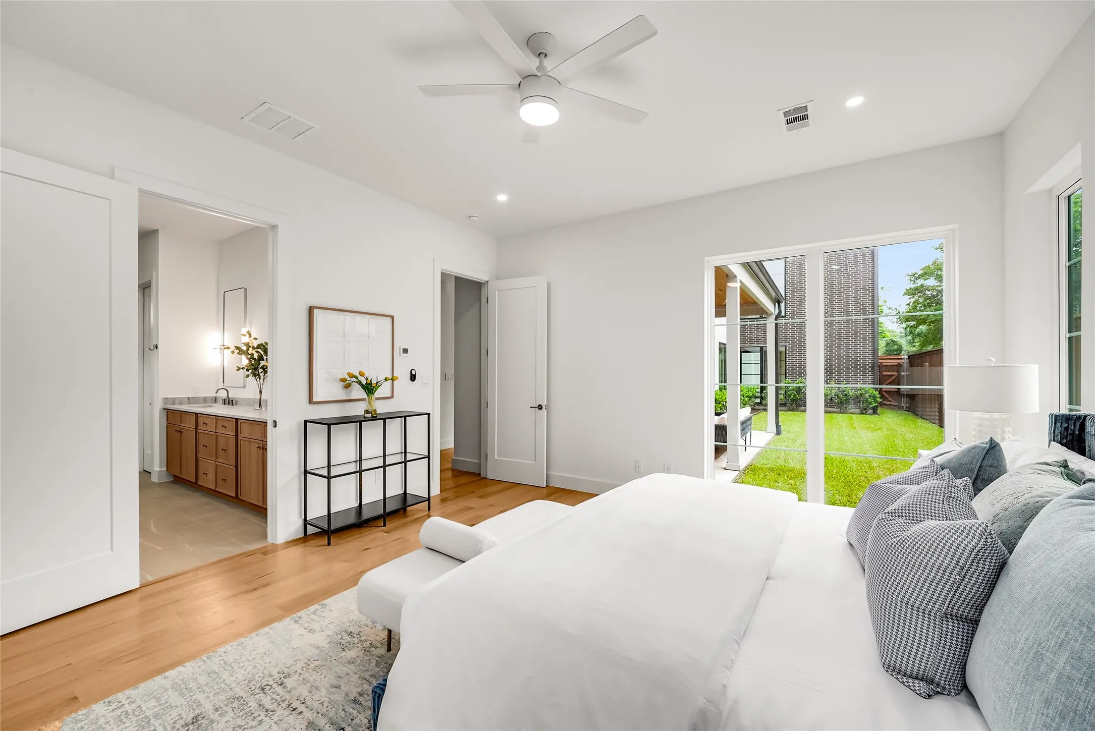Bright interior with light wood-finish flooring, recessed lighting, and a ceiling fan