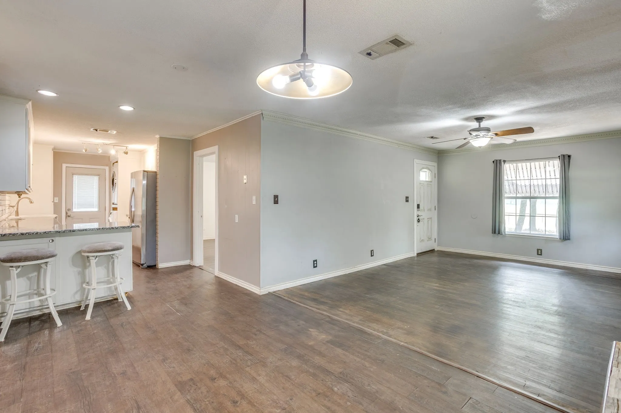 The kitchen opens into the dining and living areas.
