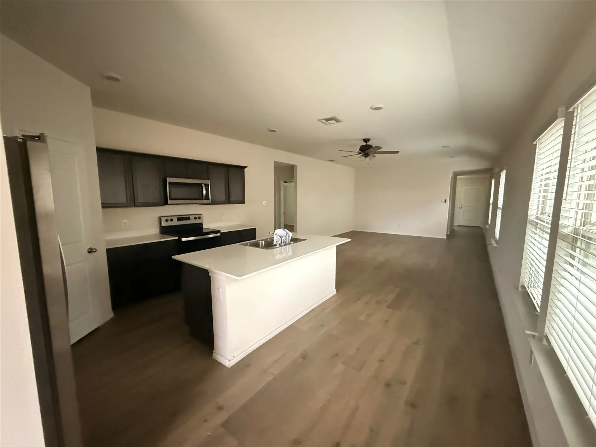 Kitchen and living area featuring wood-finish flooring