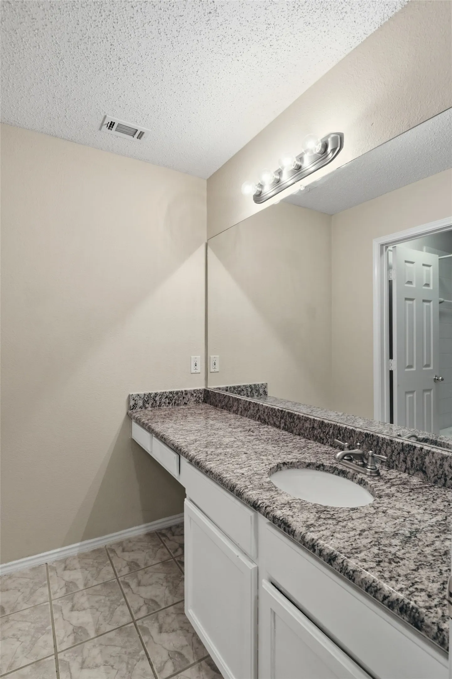 Full bathroom with seating room at vanity.