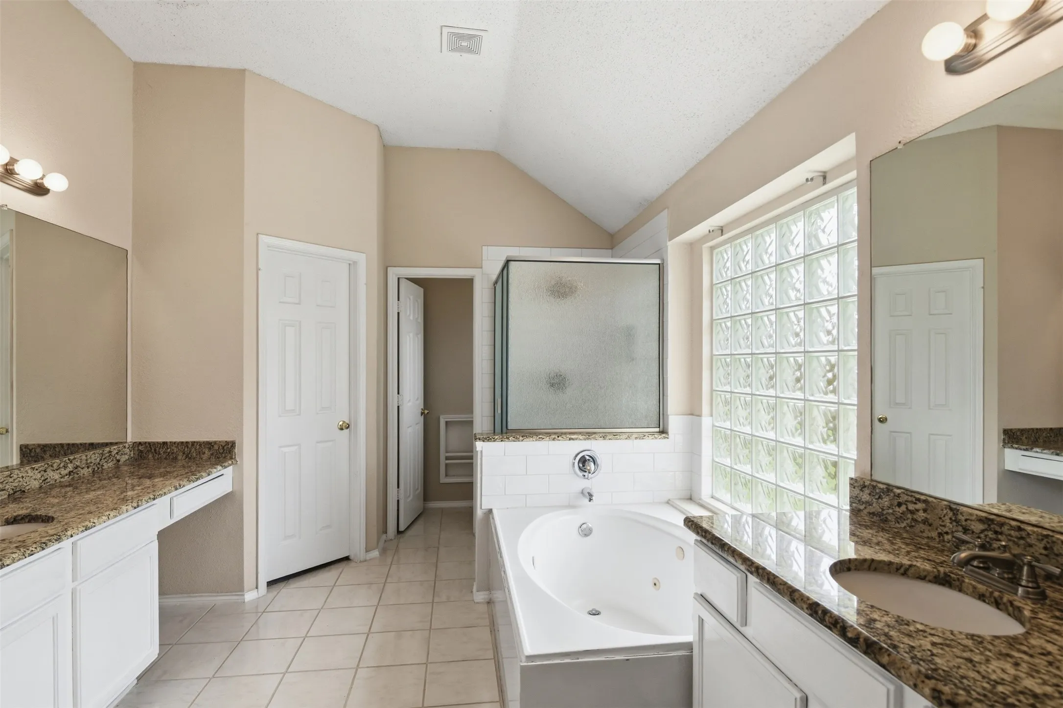 Primary bath has double vanities, sitting area, linen closet, large walk in closet and separate shower and commode with privacy in mind