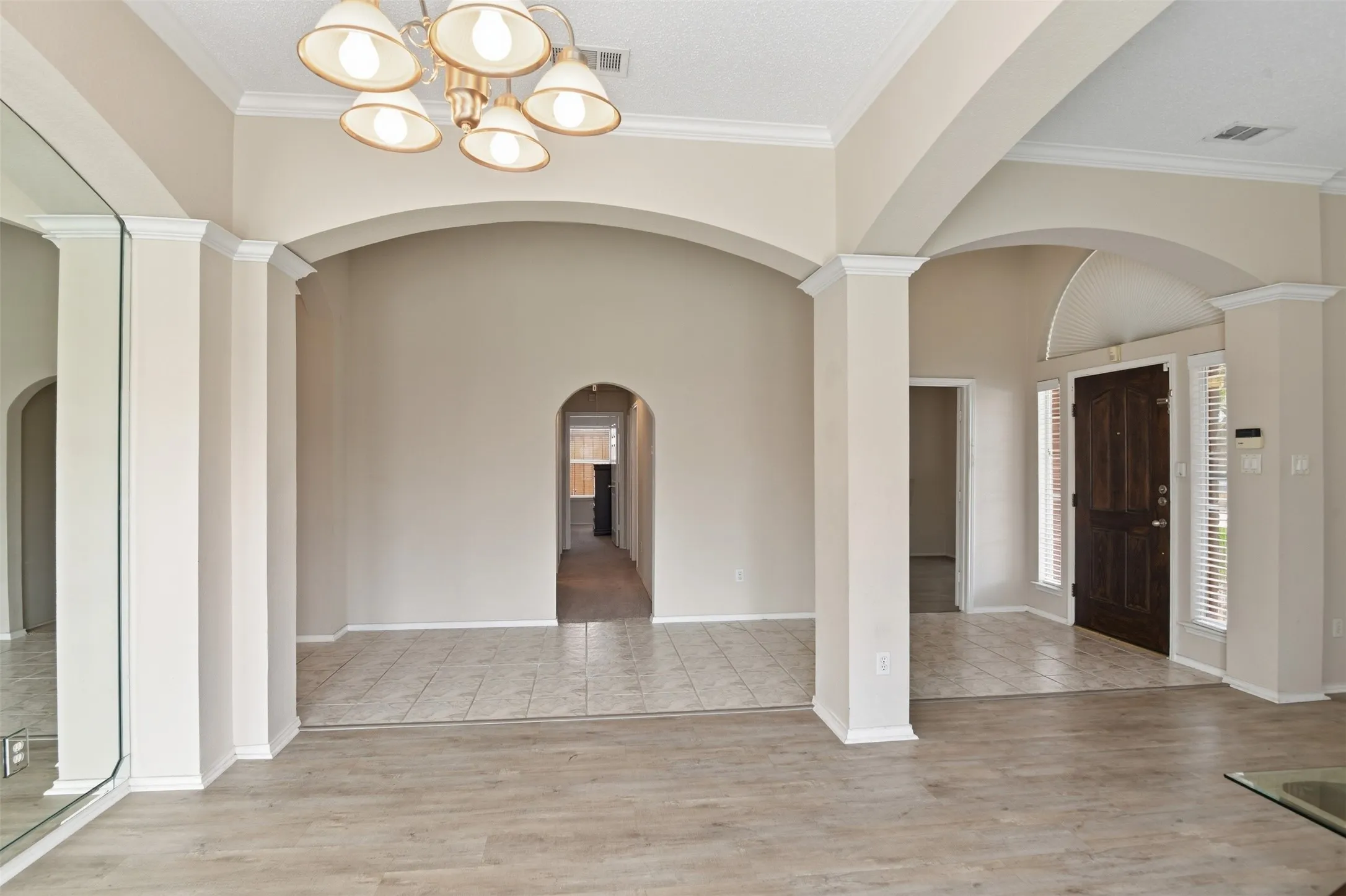 View from the dining room toward the foyer and looking down hallway to bedrooms