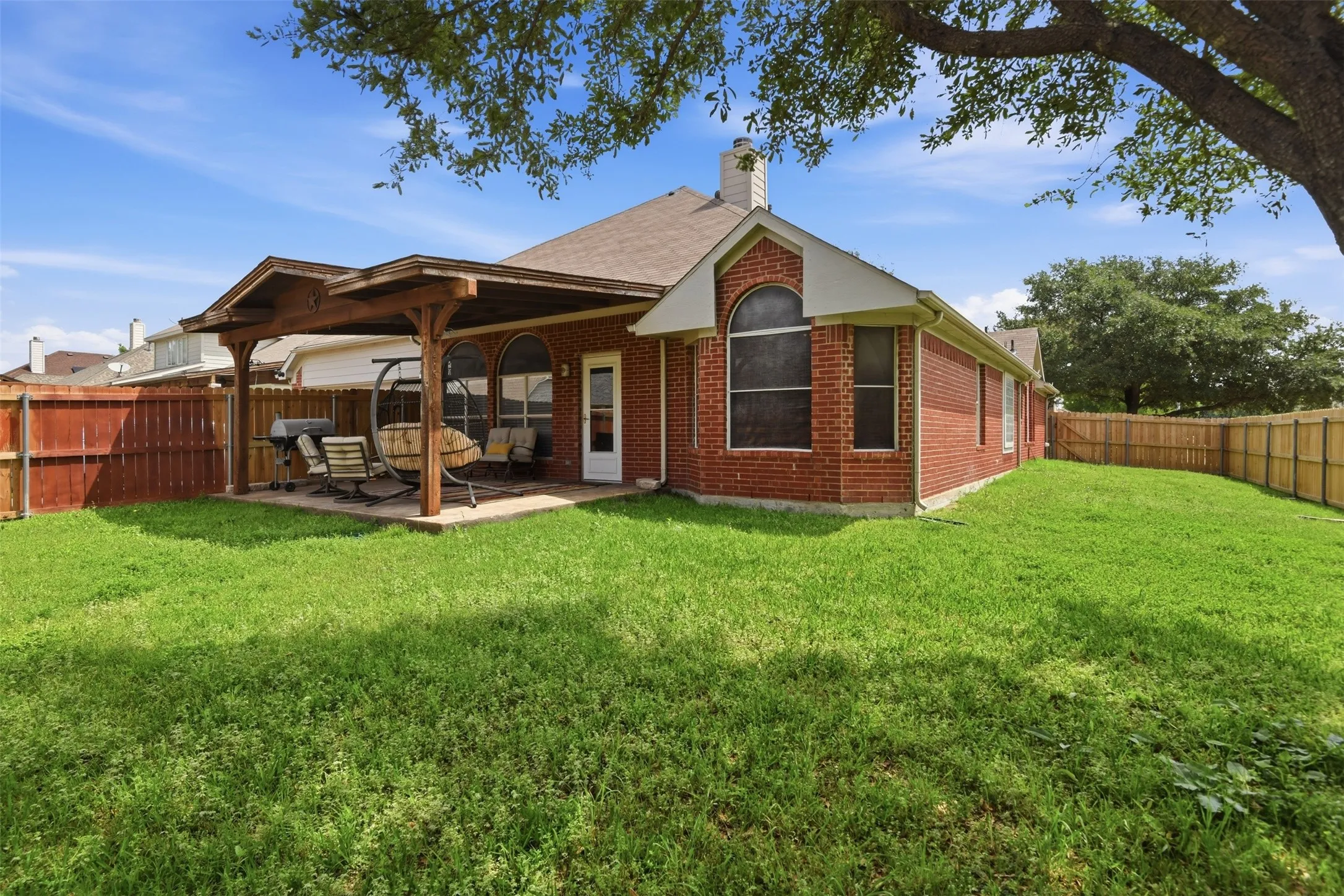 View of the back patio and the large back yard.