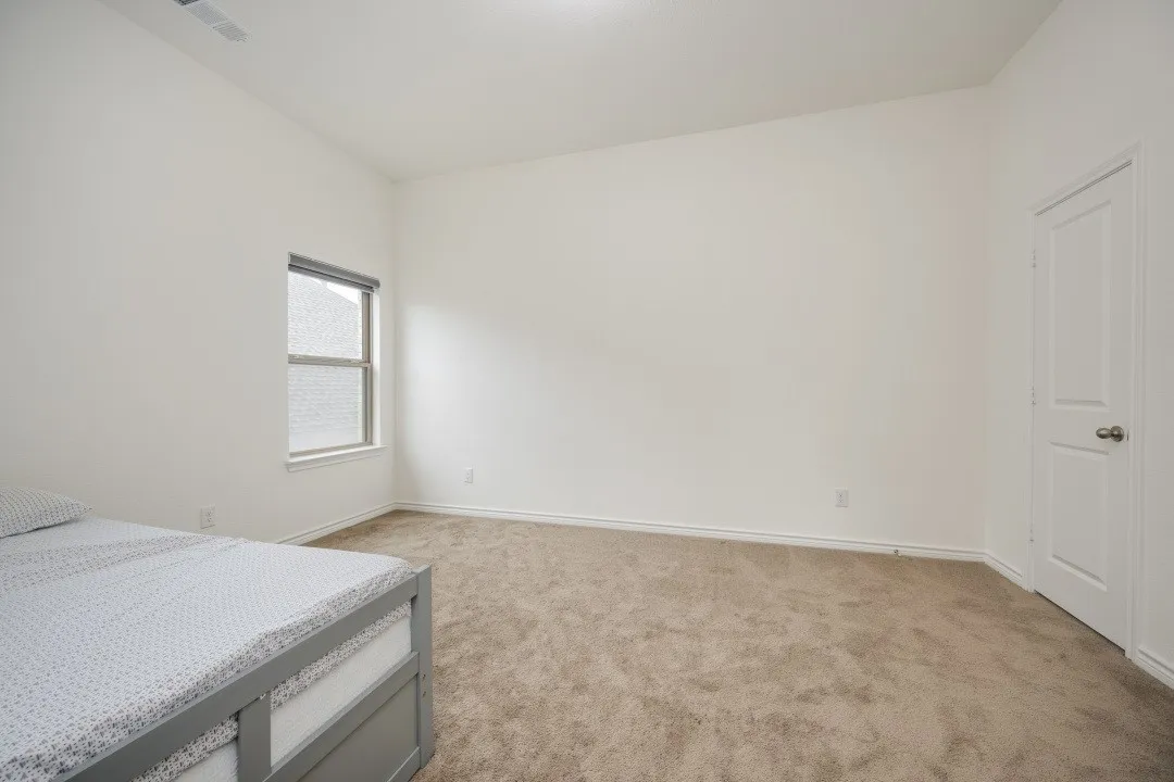 Bright room with neutral carpeting and light-colored walls