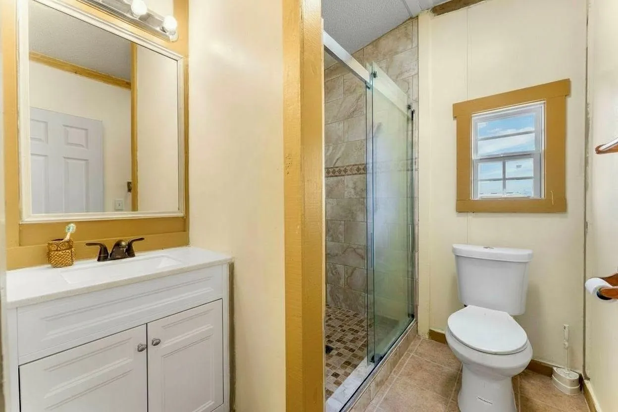 White vanity with an integrated sink and bronze-finish faucet