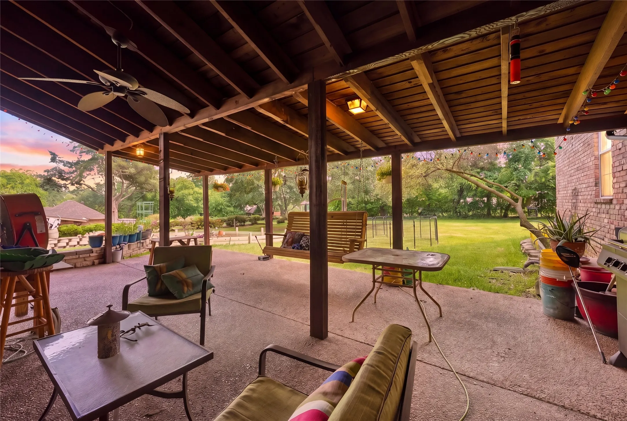 Covered patio area featuring a concrete surface and exposed wood beam ceiling