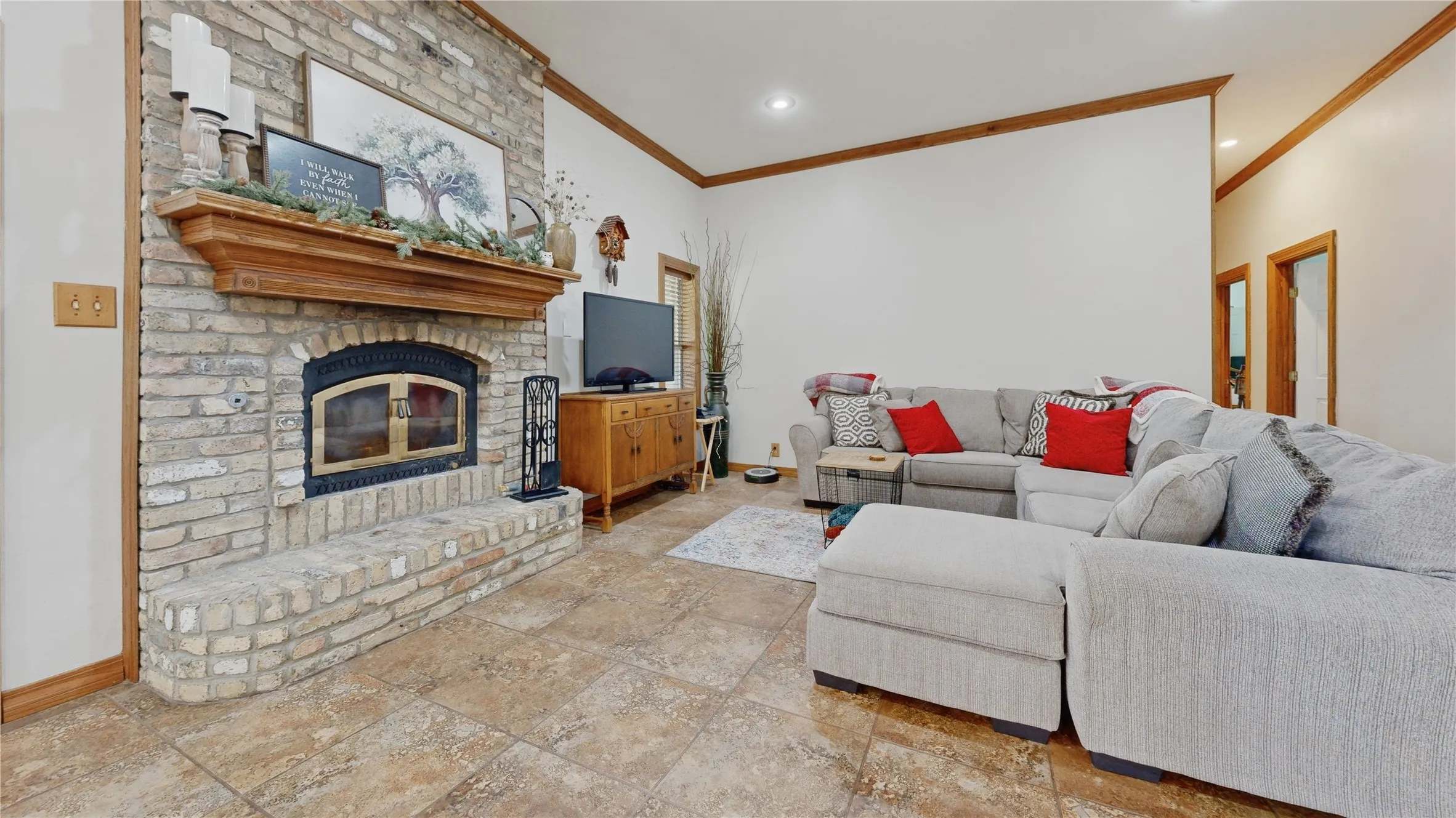 Brick-front fireplace with a wood mantel and hearth