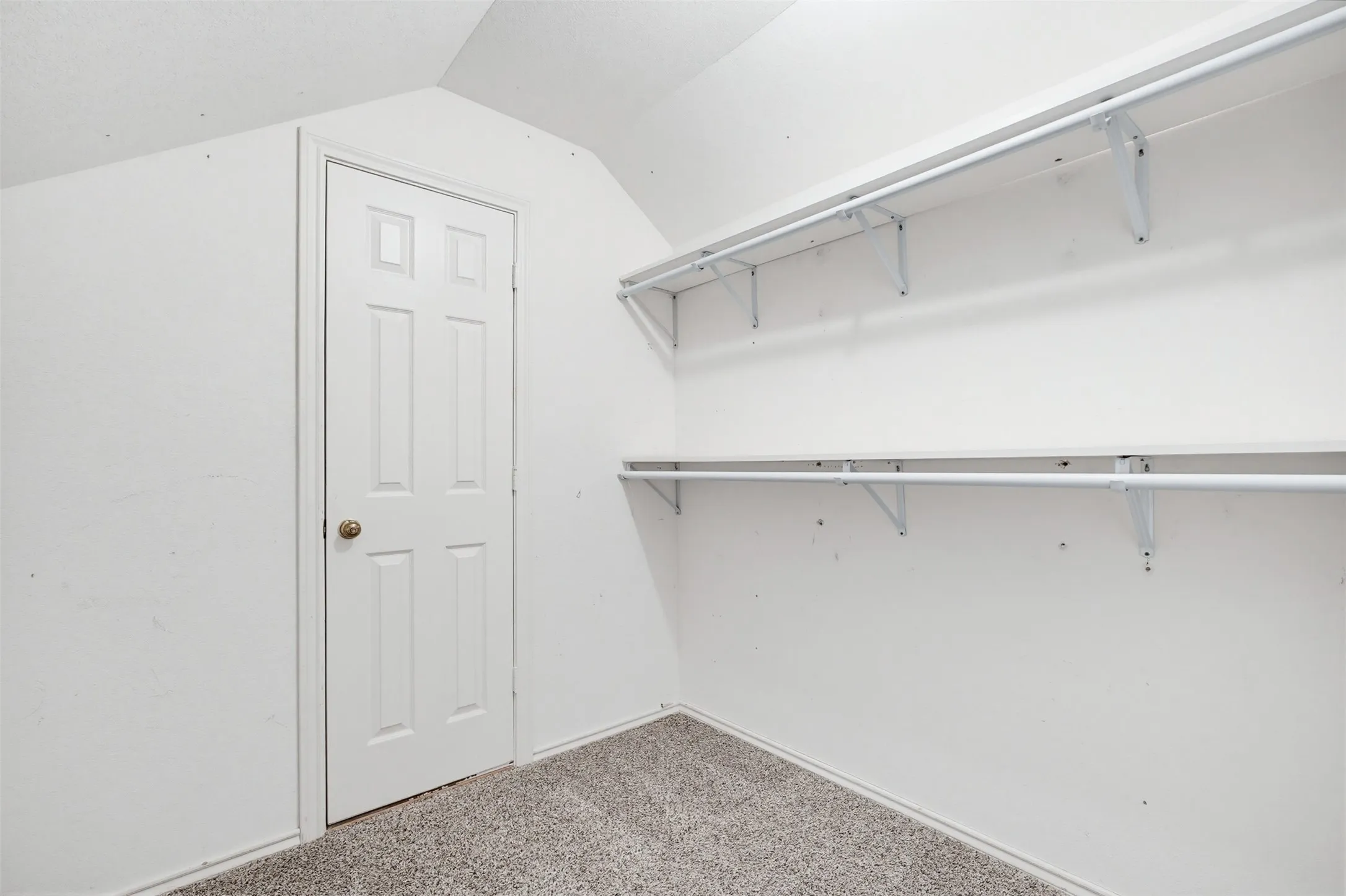 Upstairs hall closet leading to attic area.