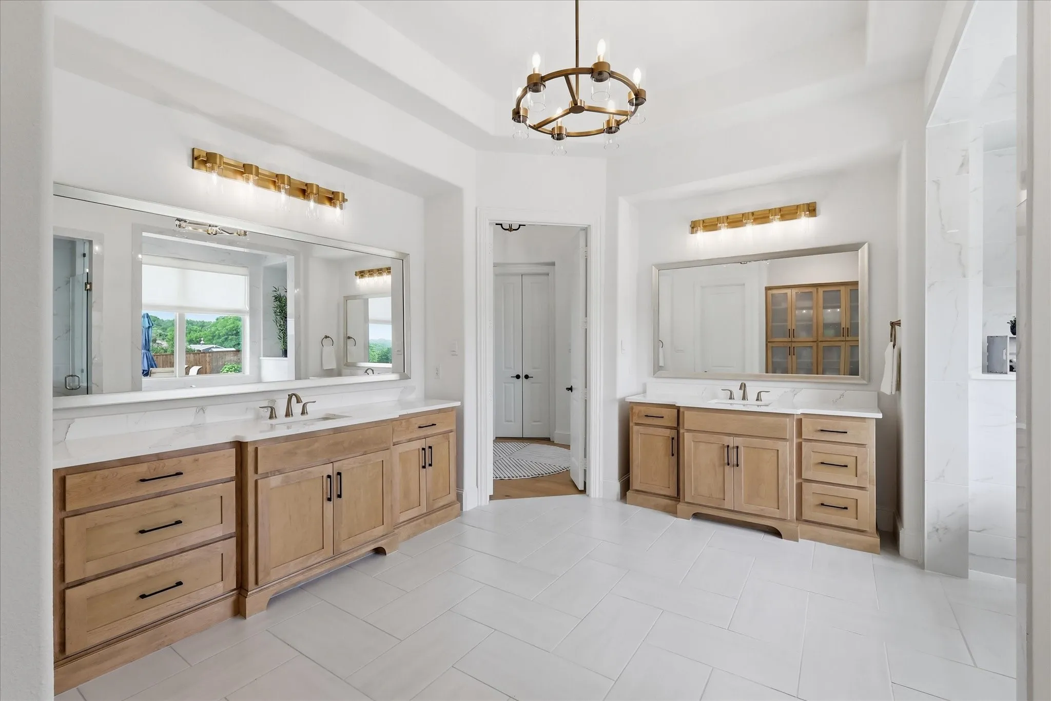 Dual wood-finish vanities with white countertops and undermount sinks
