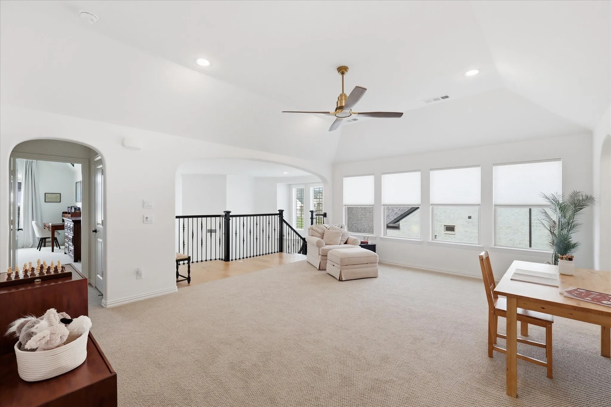 Spacious room featuring neutral wall paint, recessed lighting, and light-toned carpet flooring