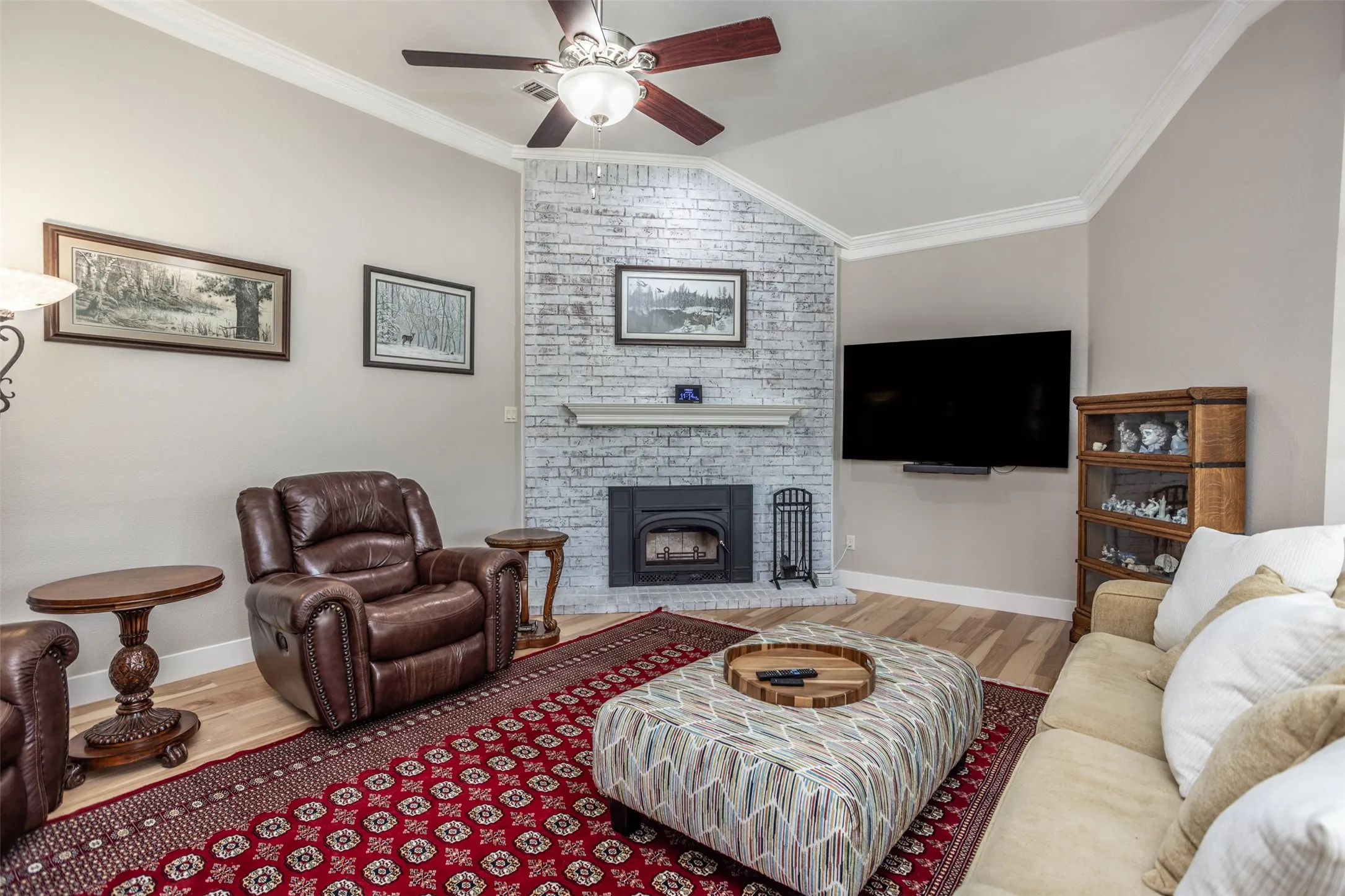 Living is anchored by corner fireplace.