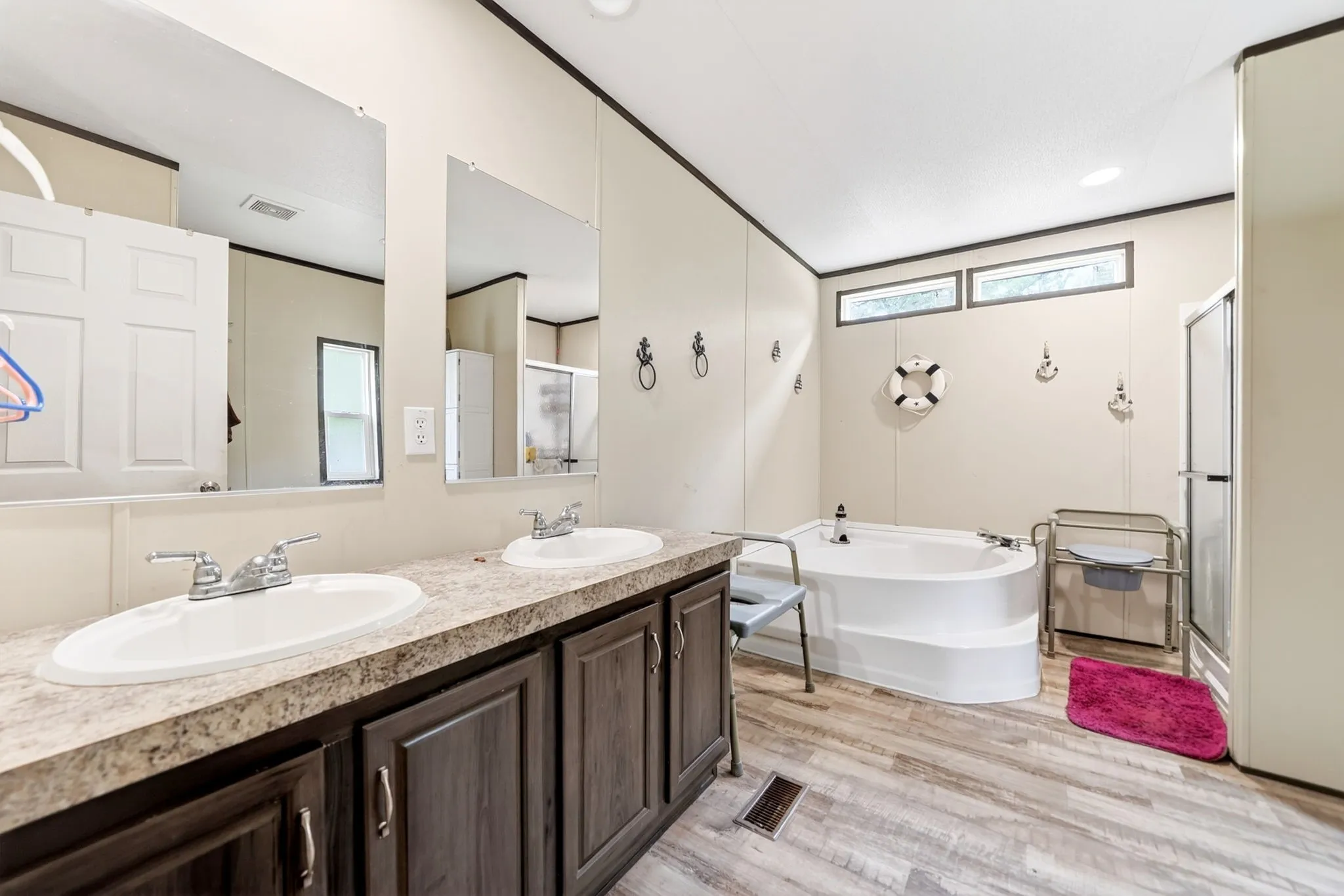 Bathroom featuring a double vanity with an integrated countertop and two undermount sinks