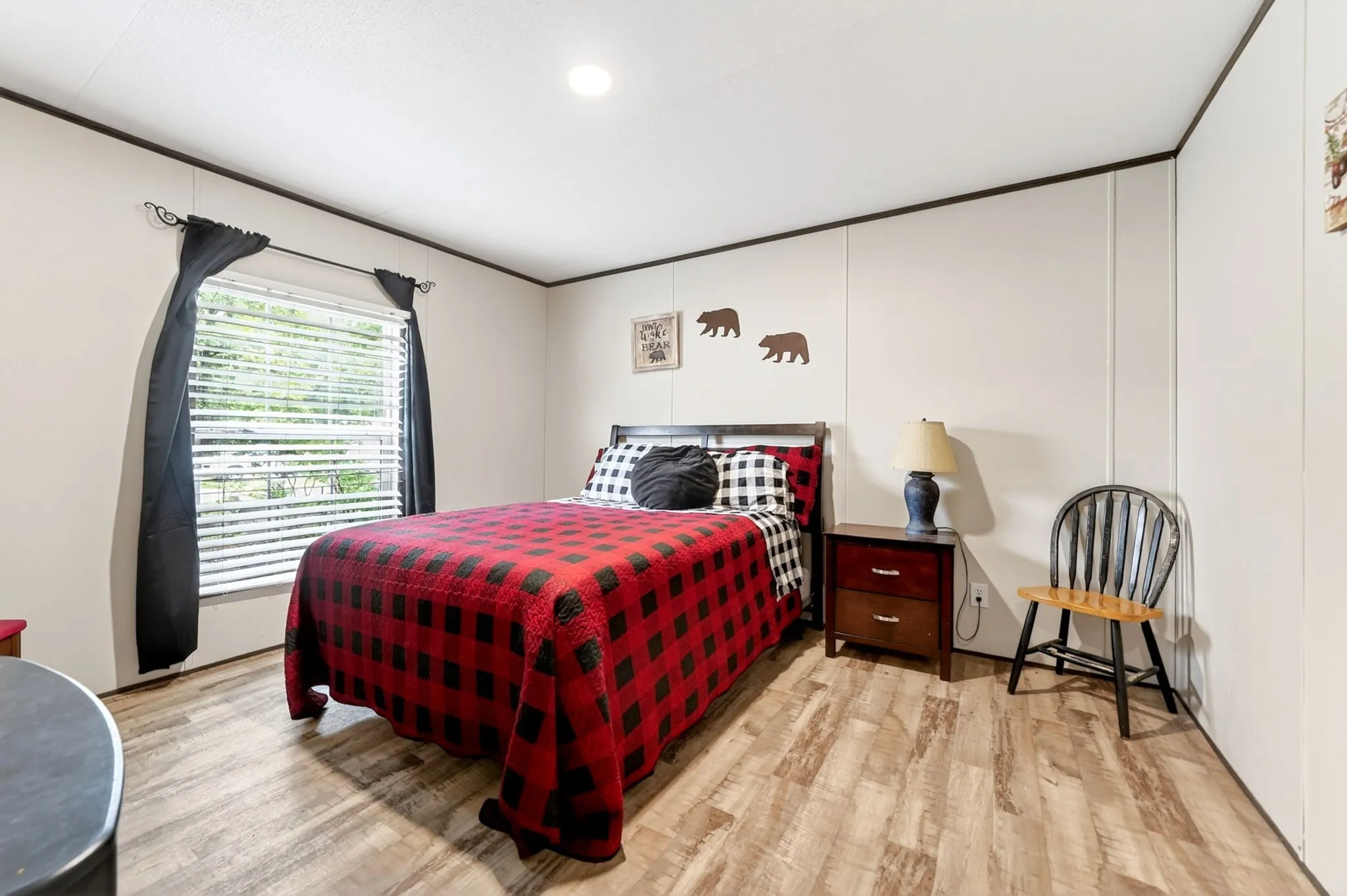Bedroom featuring wood-finish flooring, a single window with blinds, and recessed lighting