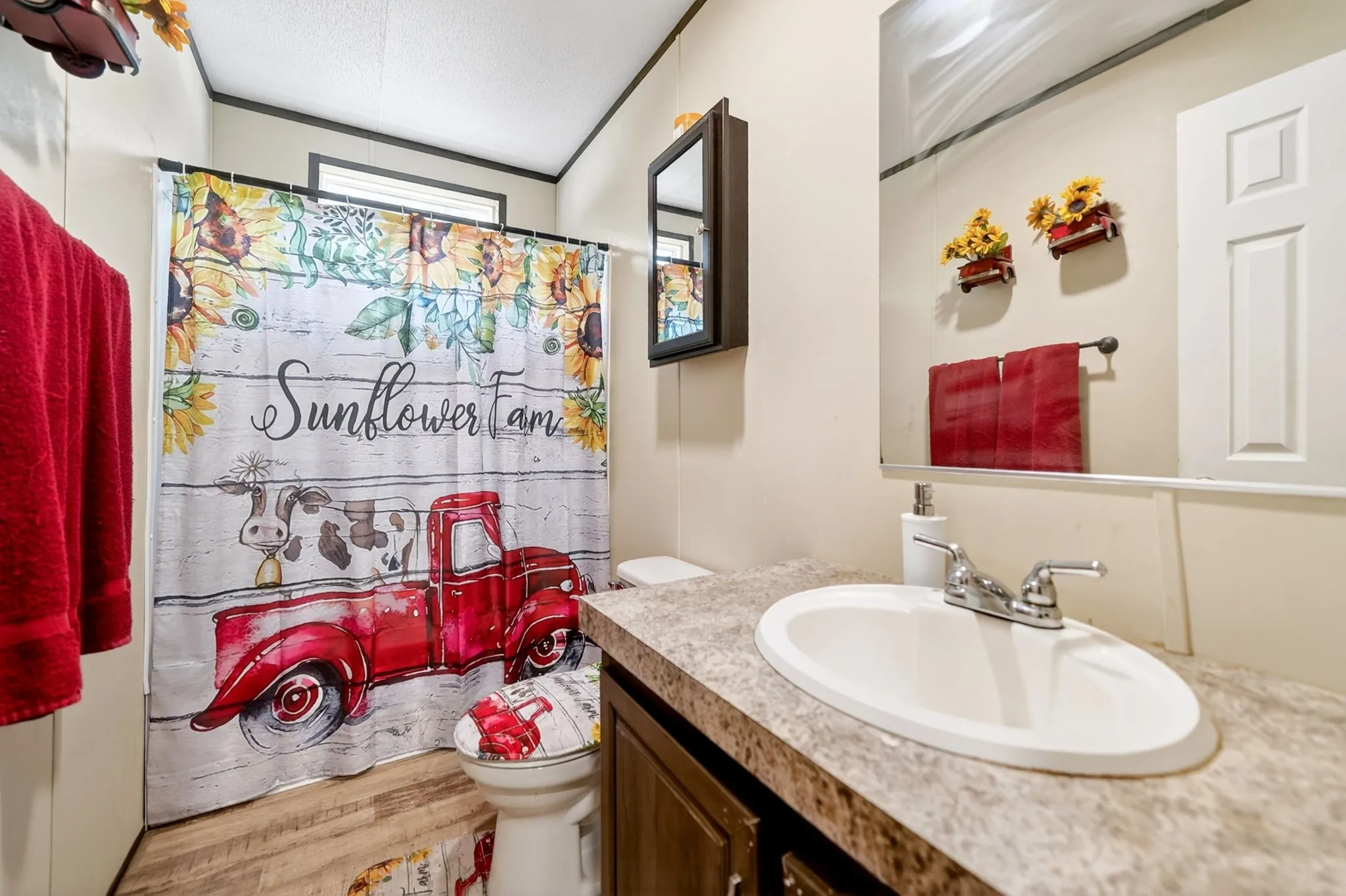 Bathroom featuring a white oval sink, chrome two-handle faucet, and a laminate countertop
