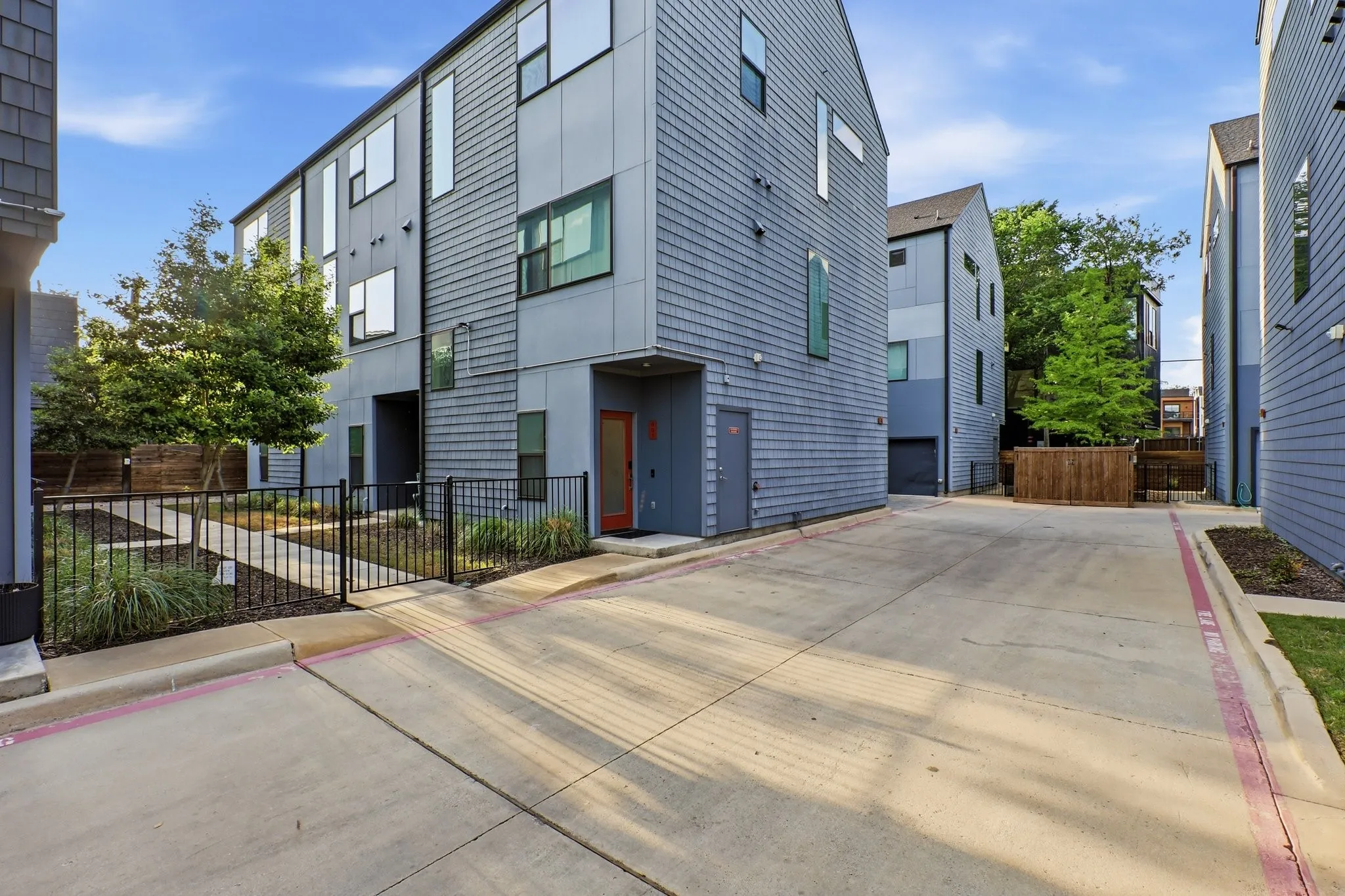 Modern multi-level townhome featuring a contemporary exterior with vertical siding and large windows