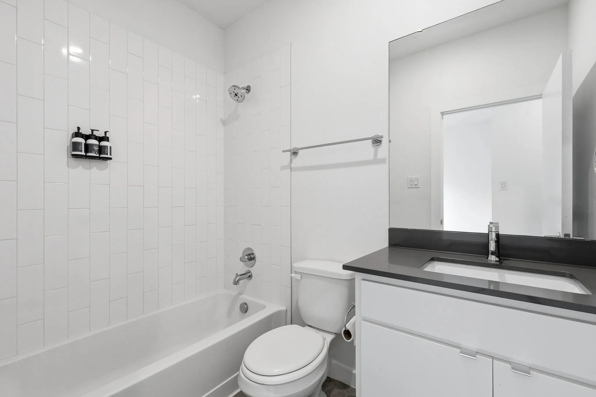 Bathroom featuring a white subway tile shower surround with a chrome showerhead and faucet