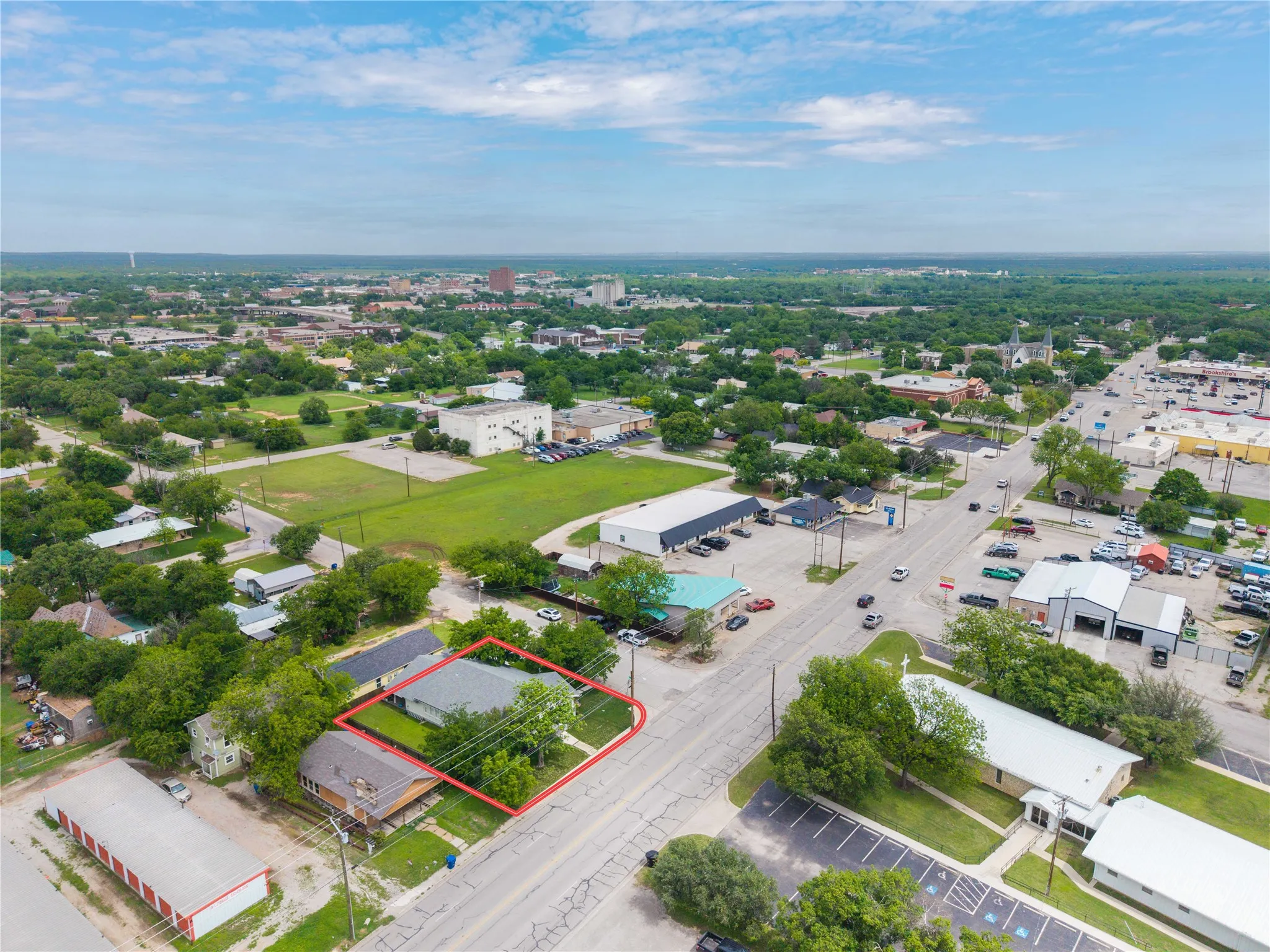 Aerial perspective showcasing a residential property with a green lawn